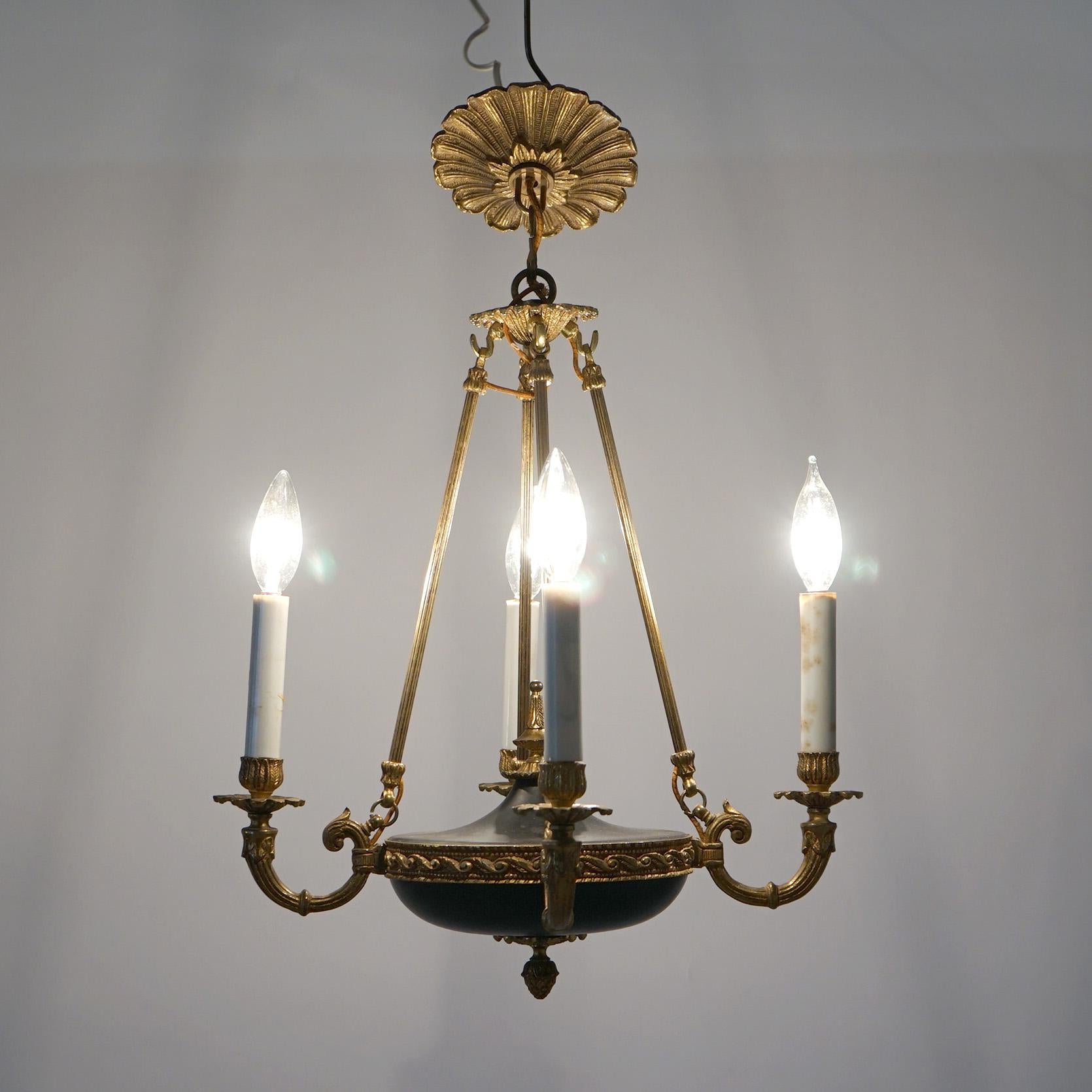 French Empire Four-Light Pan Chandelier with Gilt Metal Frame having Drop Bars, Scroll Foliate Form Arms and Embossed Mounts over an Ebonized Urn Form Font, 20th century

Measures- 22.5''H x 15.5''W x 15.5''D