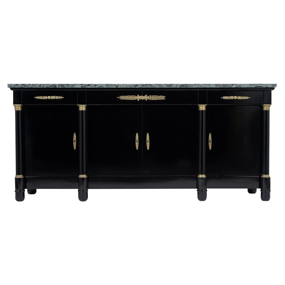A remarkable French 1970s Empire buffet handcrafted out of mahogany wood and features an eye-catching new rich ebonized color with a lacquered finish. The sideboard also has a dark green marble slab top in great condition, four drawers, and doors