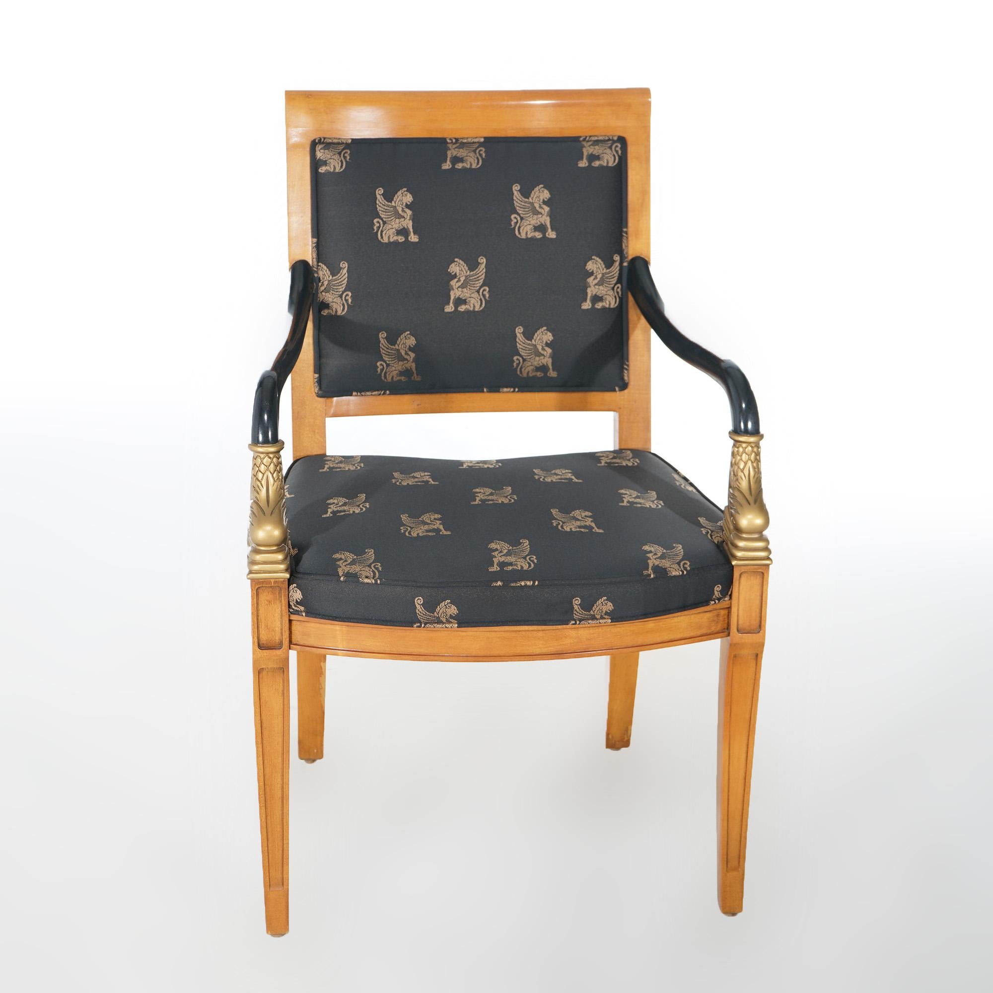 A French Empire style chair by Century Furniture offers maple frame with upholstered seat and back, flanking giltwood carved dolphins beneath each ebonized arm, and raised on slightly splayed legs; maker label as photographed; 20th