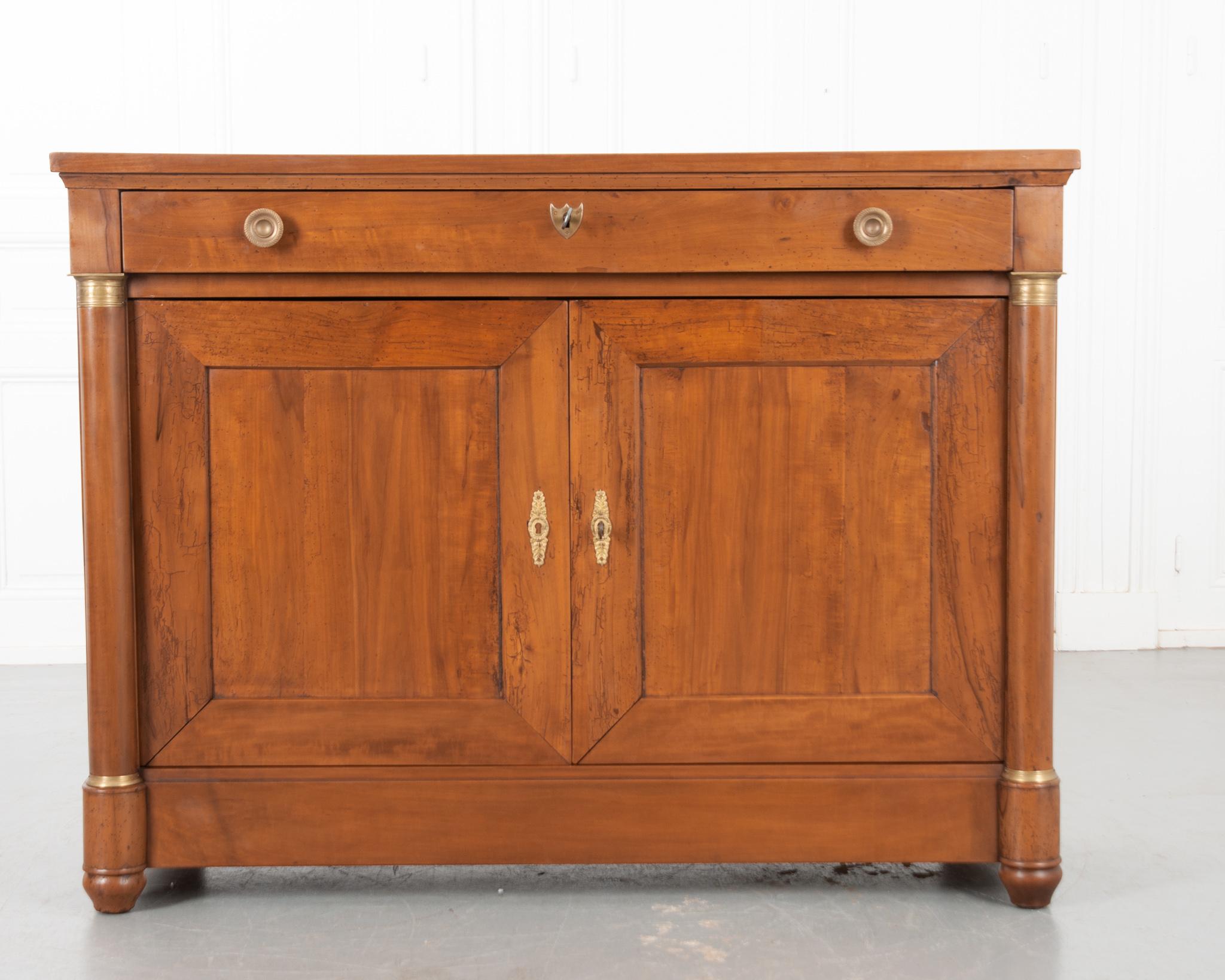 A delightful Empire style fruitwood buffet, made in France circa 1850. This wonderful antique buffet is teeming with Provincial charm. The solid antique fruitwood is beautifully patinated and an unusual wood for an Empire style piece. A single