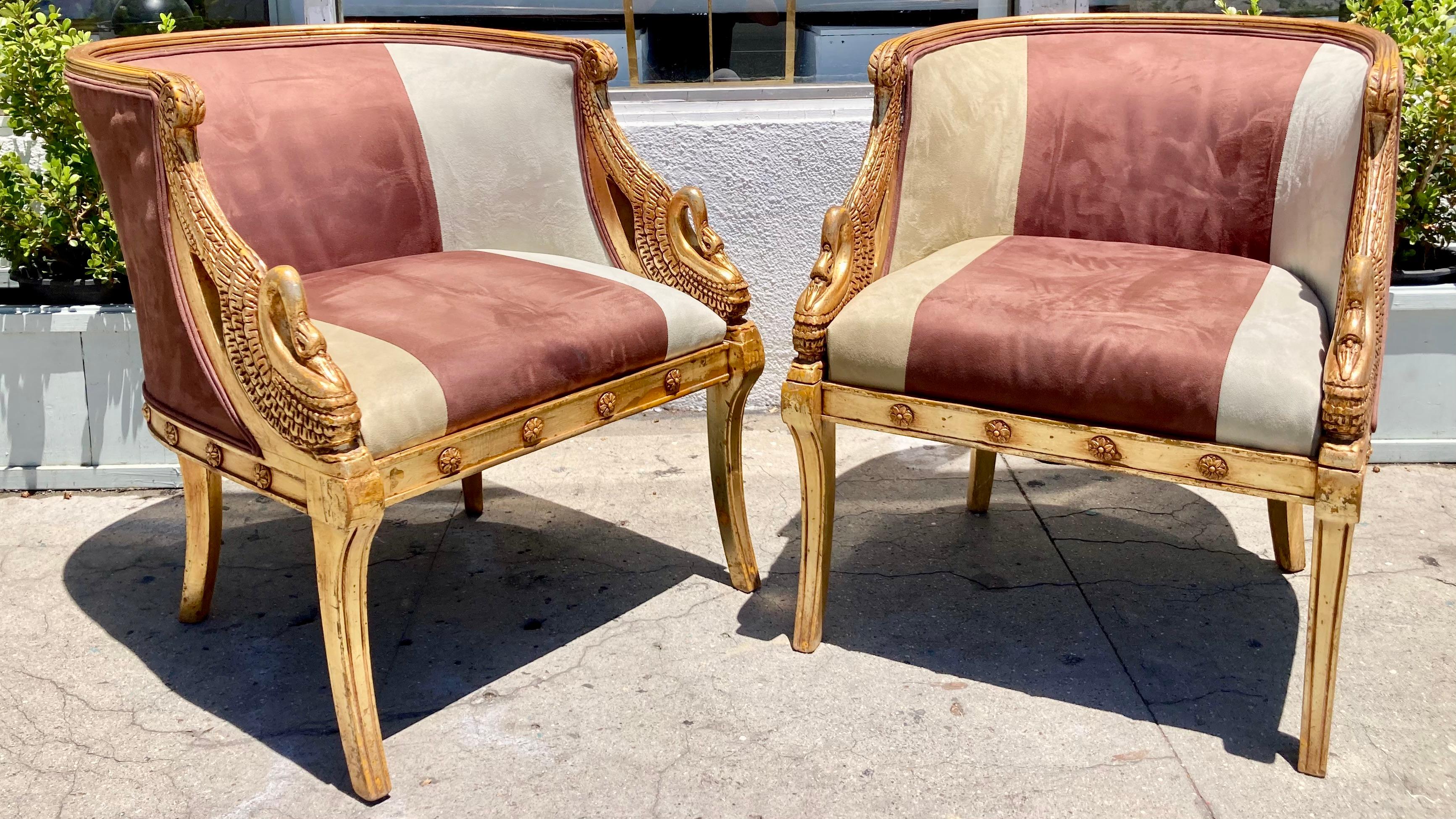 French Empire pair of gilt barrel back bergeres with beautiful carving details on swans. Nice upholstery. Keep as is is or recover for your design project. Add some classic French style to your project.