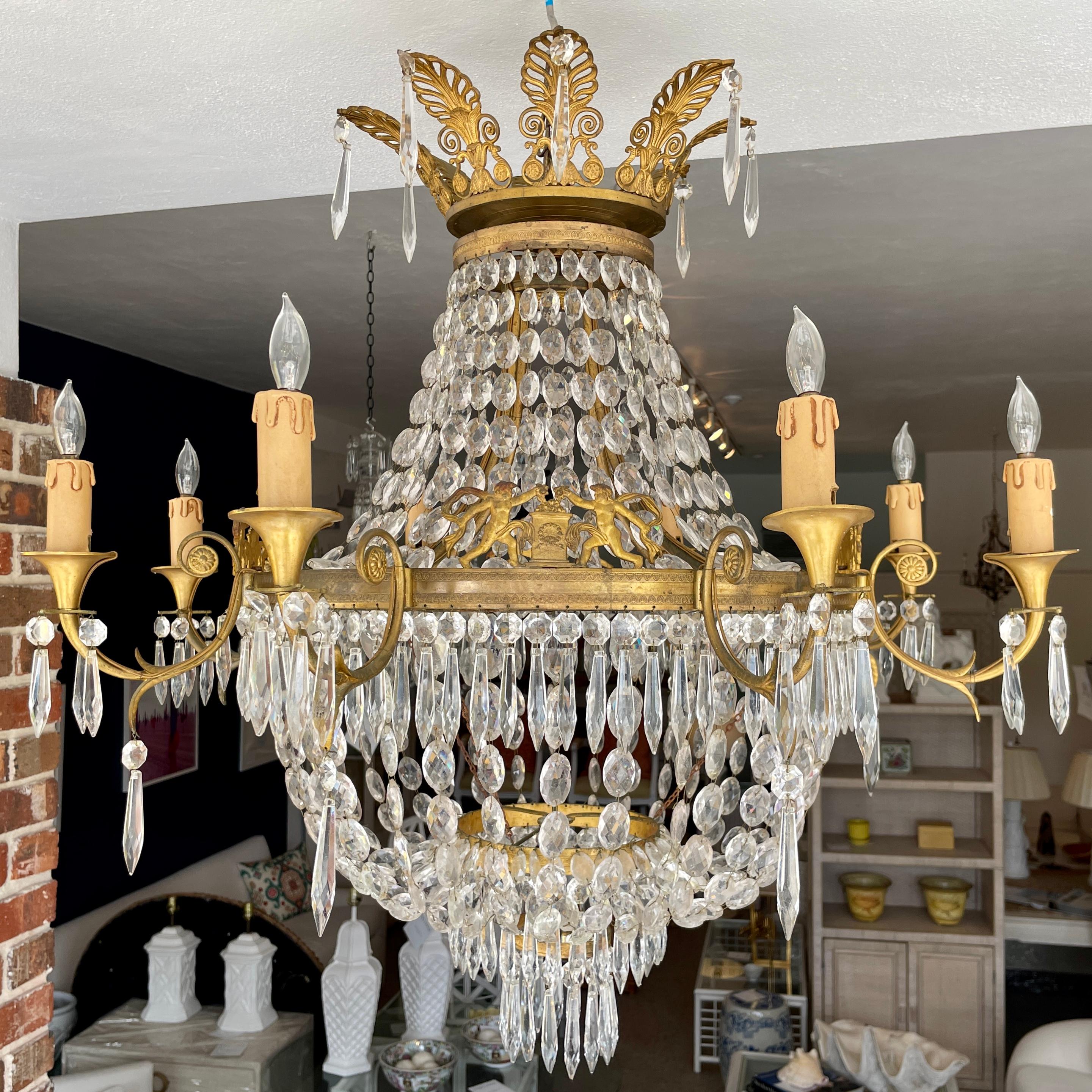 Beautiful French Empire Gilt Bronze and crystal chandelier. Amazing carving details on all sides of the bronze frame and the leaves crest at the top. Add some French Style to your home.