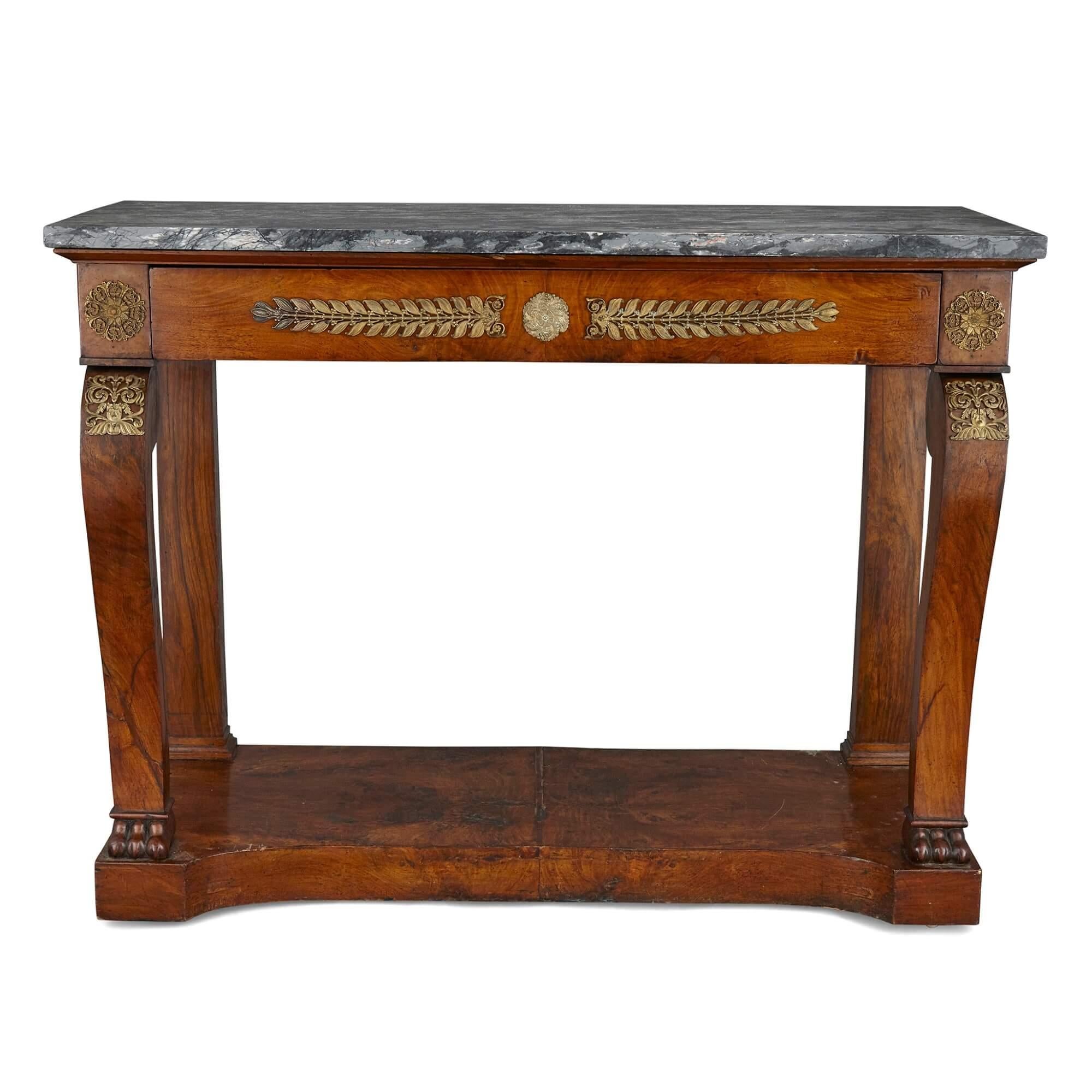 French Empire gilt bronze and mahogany console table
French, early 19th Century
Height 92cm, width 120cm, depth 51cm

This elegant console table is a superb example of French Empire period design. The console table features a veined grey marble