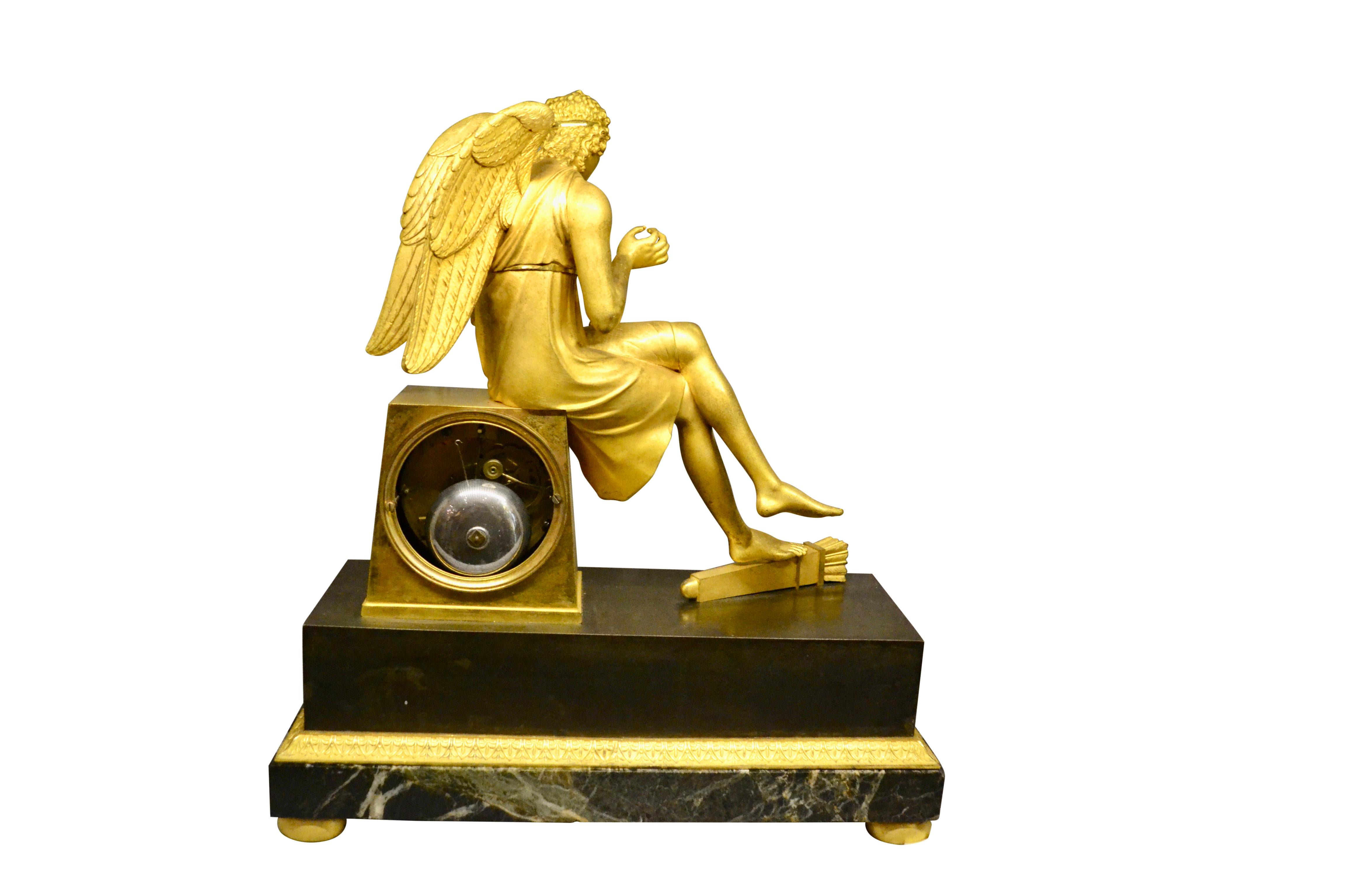 French Empire Gilt Bronze and Marble Clock of Seated Cupid Holding a Rose For Sale 1