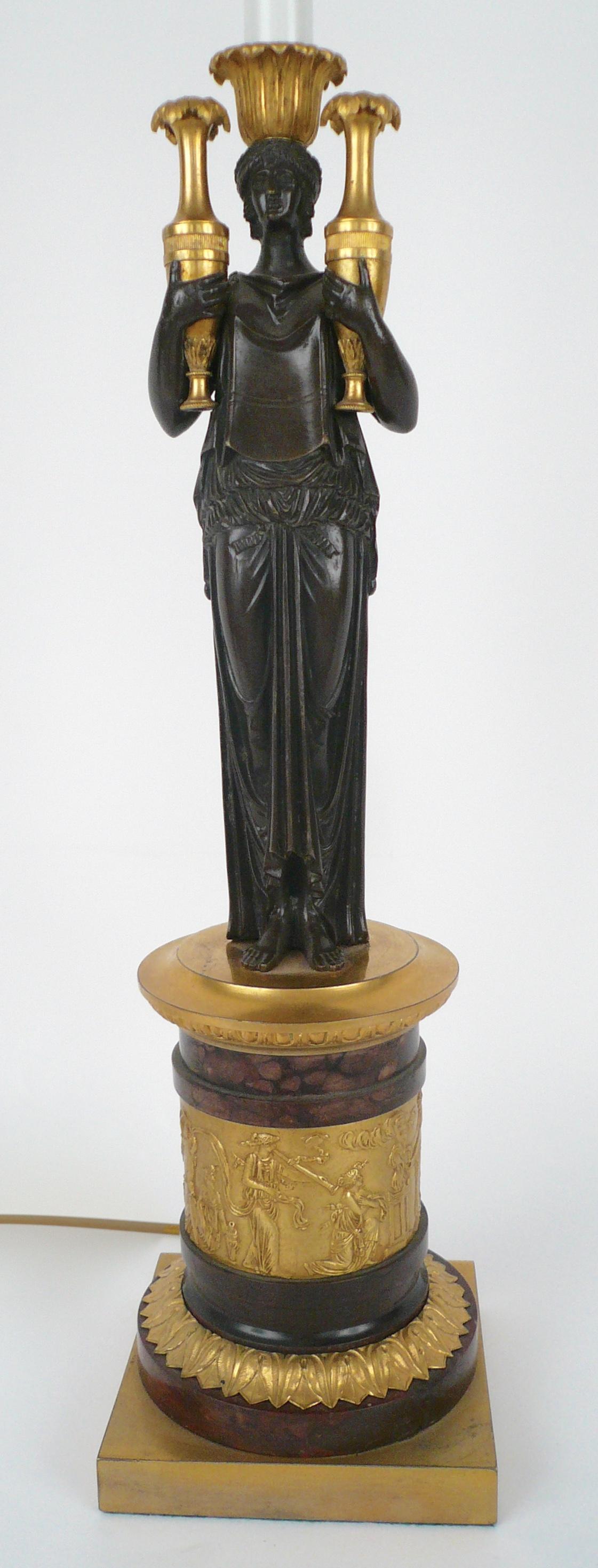 This fine quality lamp base features a gilt classical frieze, and a patinated bronze figure of a classical maiden.