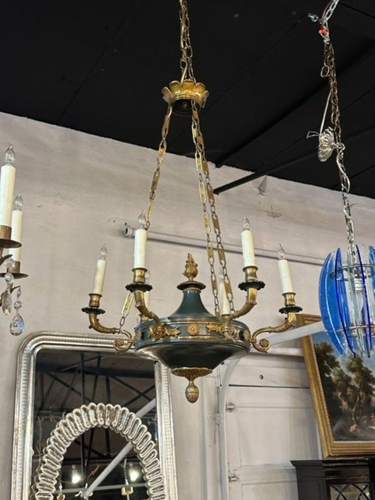 Early 20th century French Empire gilt bronze and tole 6-light chandelier. Circa 1920. The chandelier has been professionally rewired, comes with matching chain and canopy. It is ready to hang!
