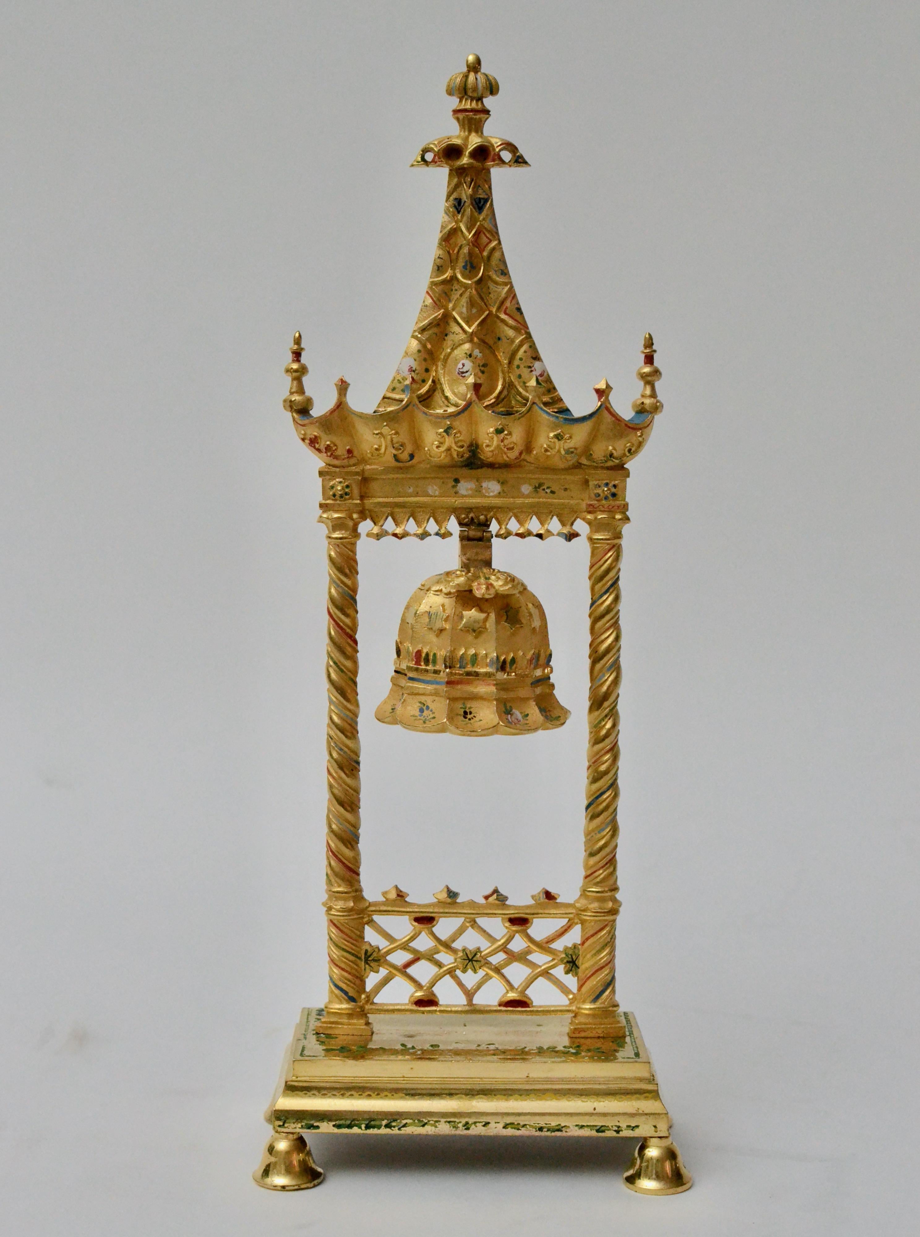 19th century French empire gilt bronze servant bell in the chinoiserie style. In the shape of a miniature pagoda bell tower or steeple housing bells. The gilding with some decorative painting C.1825.