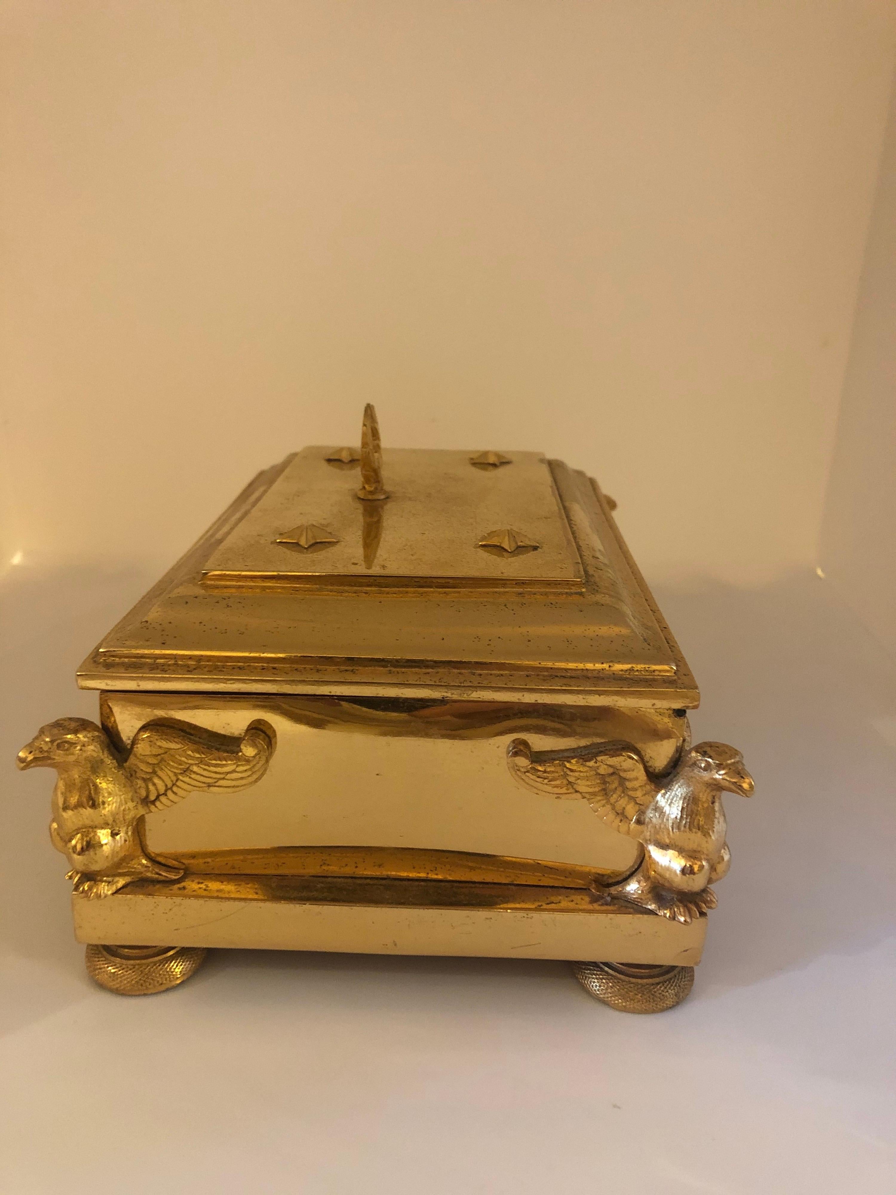 French Empire gilt bronze box with tooled leather interior. The decoration being eagles wreaths and griffons.