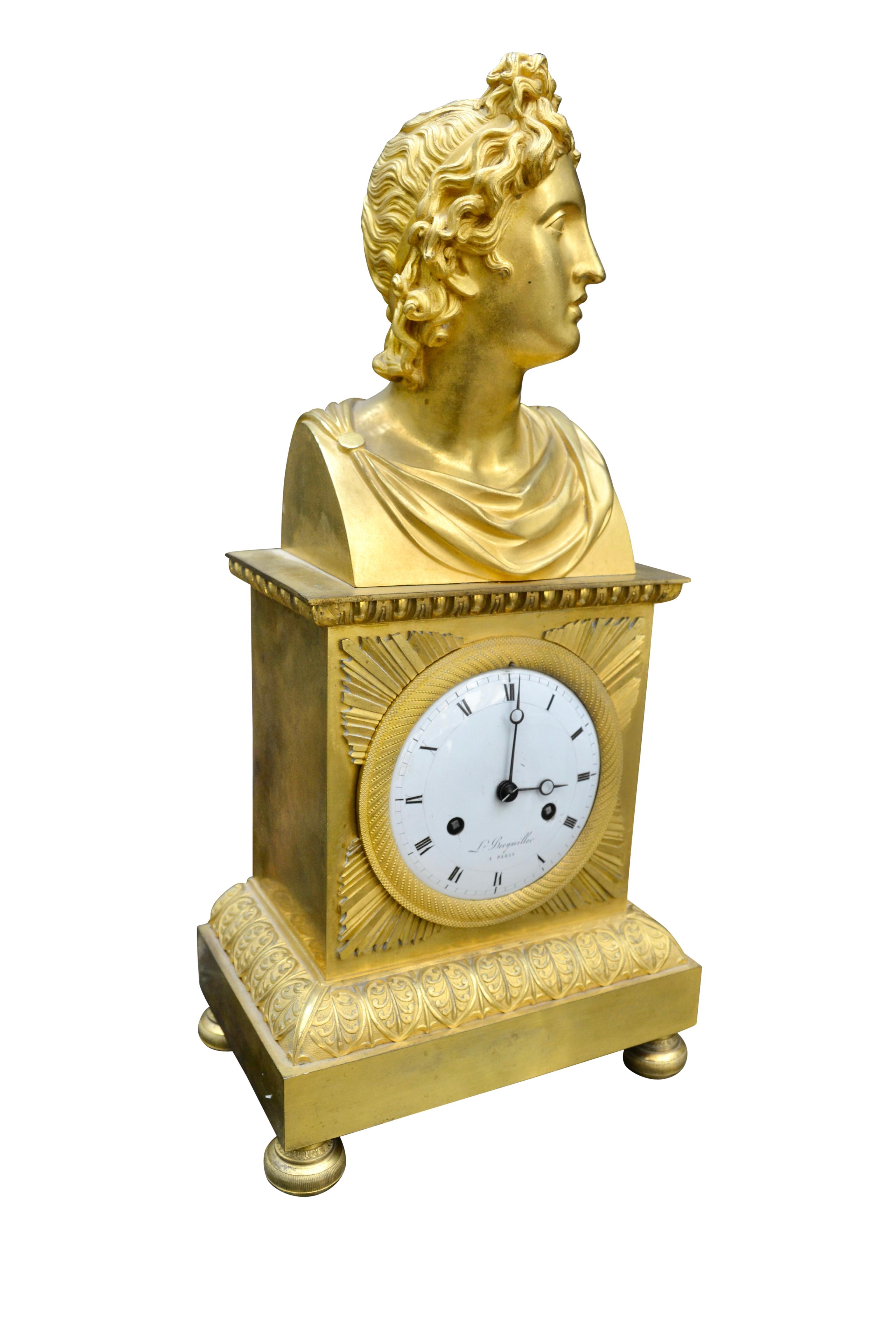 A period French Empire Apollo Belvedere mantle clock in gilt bronze, the rectangular plinth on a stepped base richly decorated with acanthus. The plinth itself houses the large white enamel dial signed “L. Bergmiller A PARIS”; the original movement