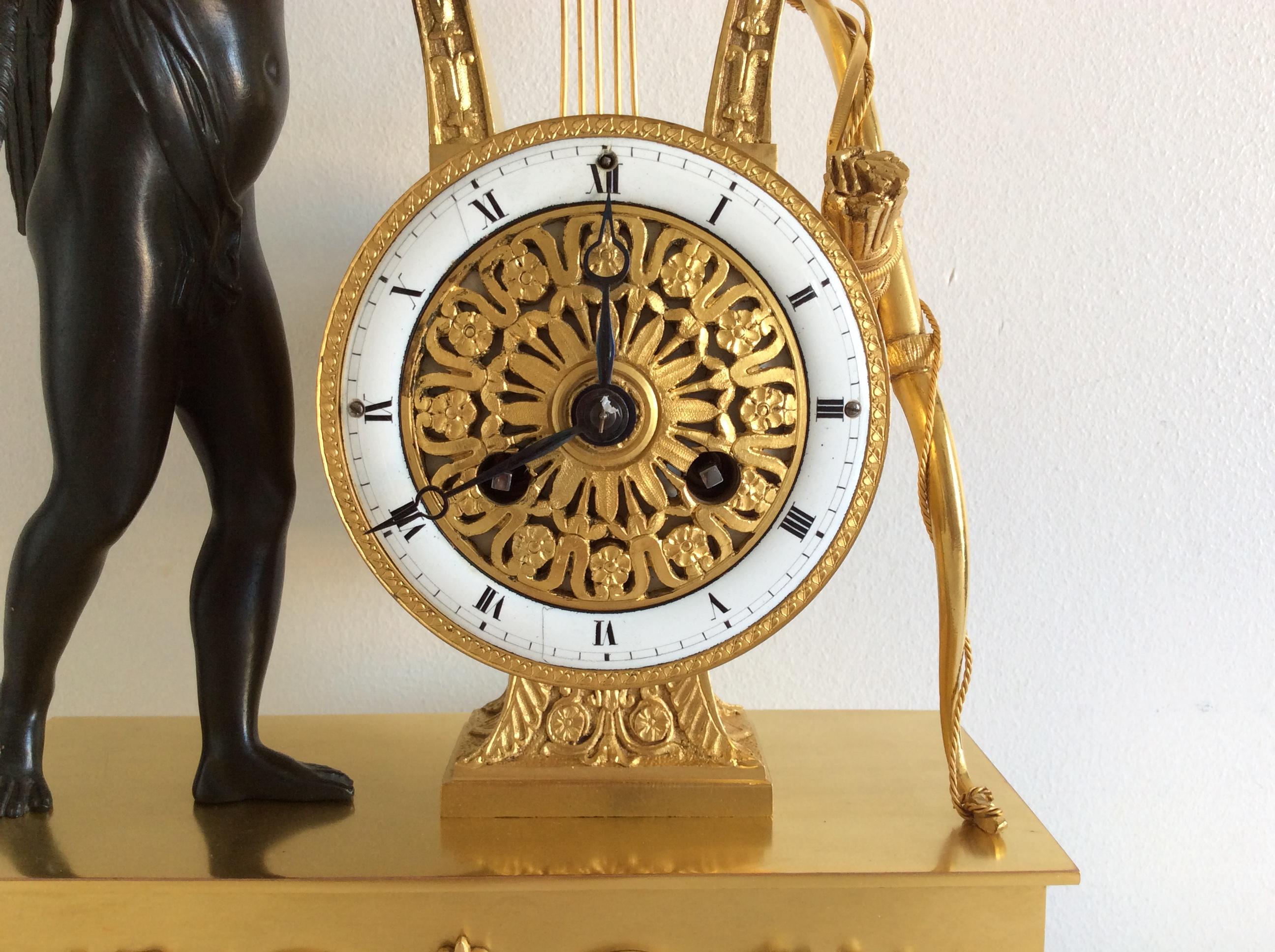 A very beautiful French gilt bronze clock with Cupid playing on lyre, base is on four lions paw feet, very nice and clean gilt.
