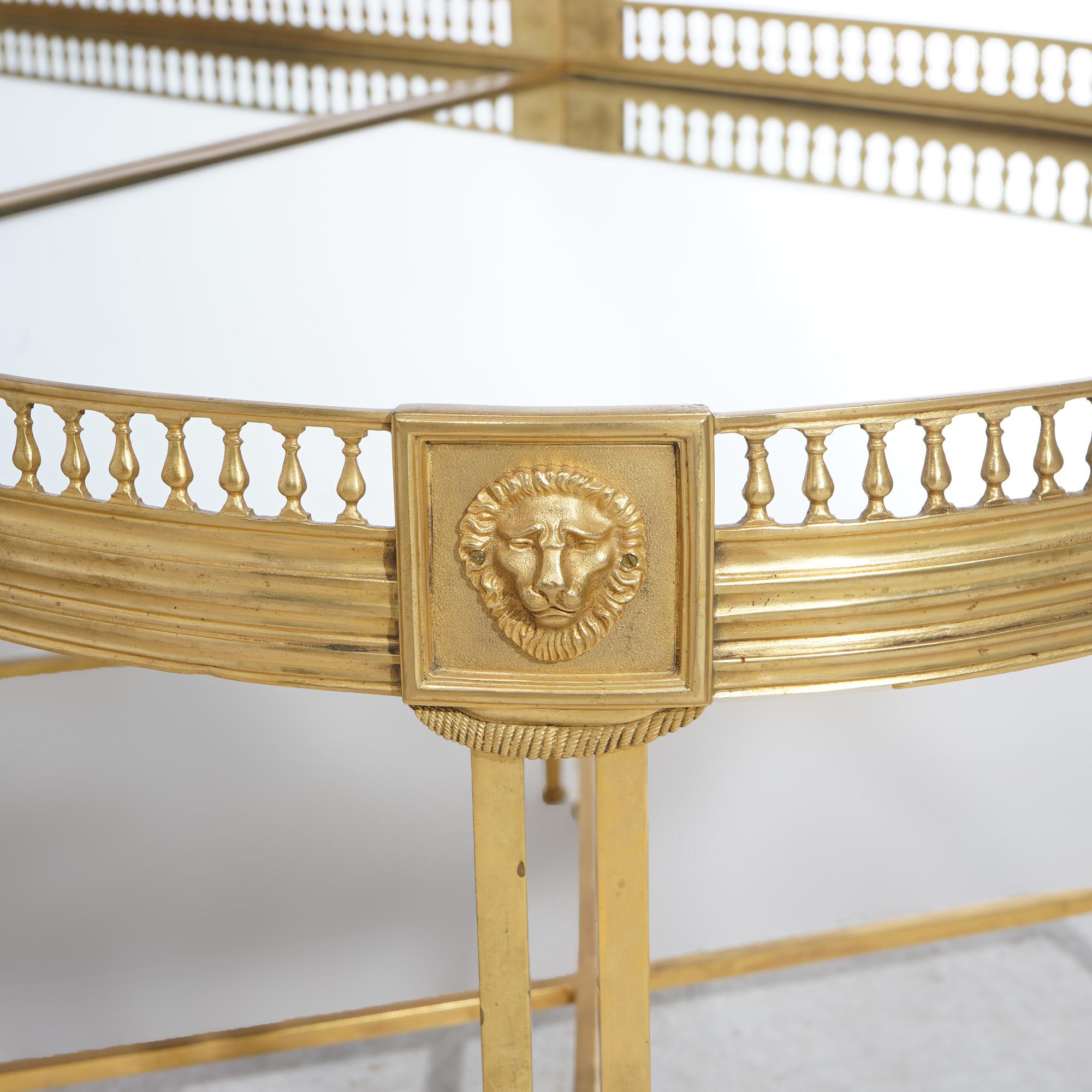 ***Ask About Reduced In-House Shipping Rates - Reliable Service & Fully Insured***
A French Empire style low table offers gilt bronze construction in oval form with mirrored top having pierced gallery border over base with figural lion heads and