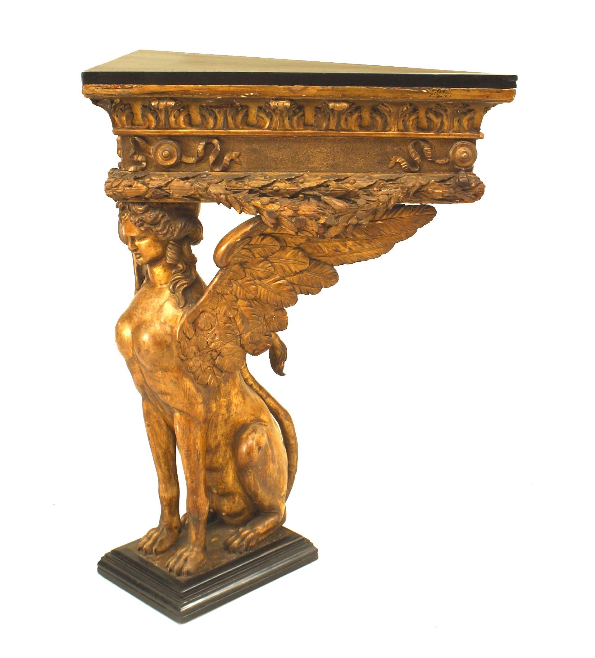 French Empire gilt sphinx carved triangular console table with black painted top.
 