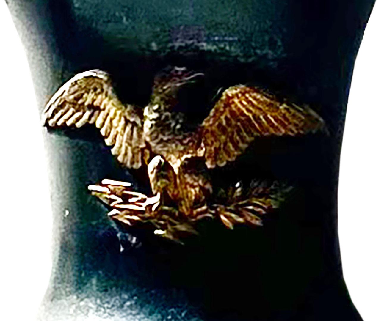 A French empire garniture in bronze and marble. The bronze with a dark patina in some places.  An ormolu and gold French eagle on the front and a wreath at the bottom of the urn. Circa 1830s.