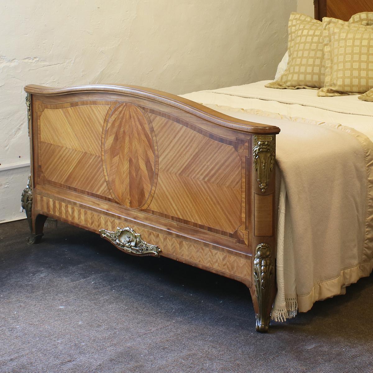 A French Empire style mahogany bedstead with stunning brass ormolu decoration, lions brass feet and parquetry sunburst on the footboard.

This bed accepts a British King size or American Queen size, 5ft wide (60 inches or 150cm) base and mattress