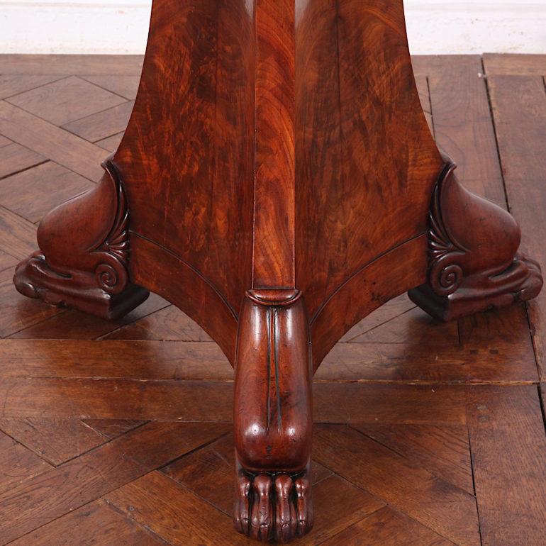 French Empire mahogany center table with unusual granite top and carved feet, circa 1820.