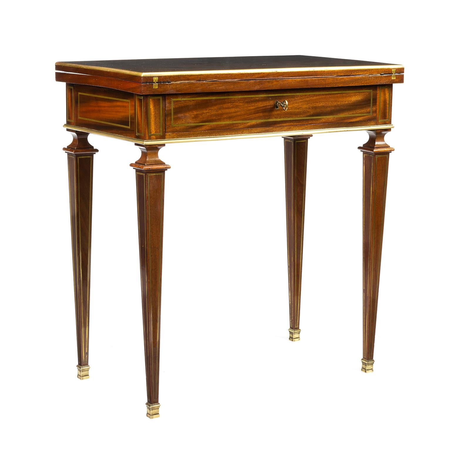 A French Empire combination writing, card table and dressing table. Mahogany with finely inlaid cut brass and a vacant cartouche within an ornate scroll frame, line inlaid borders. The purple felt interior within gilt tooled leather borders, the
