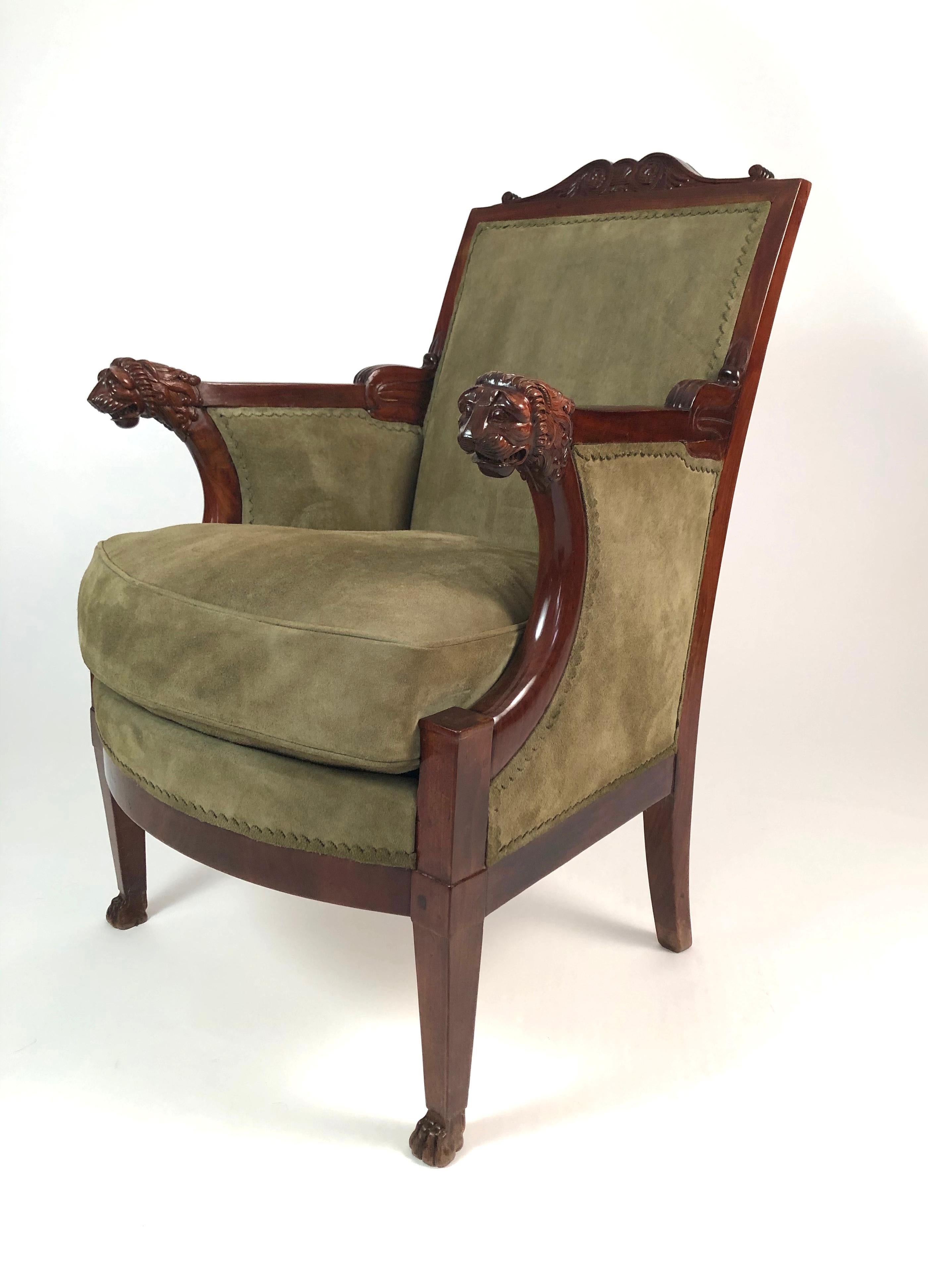 A fine quality French Empire period fauteuil, a generously proportioned armchair, in mahogany, and upholstered to the highest standards in sage green suede with scalloped trim and full down seat cushion, the canted rectangular back with carved
