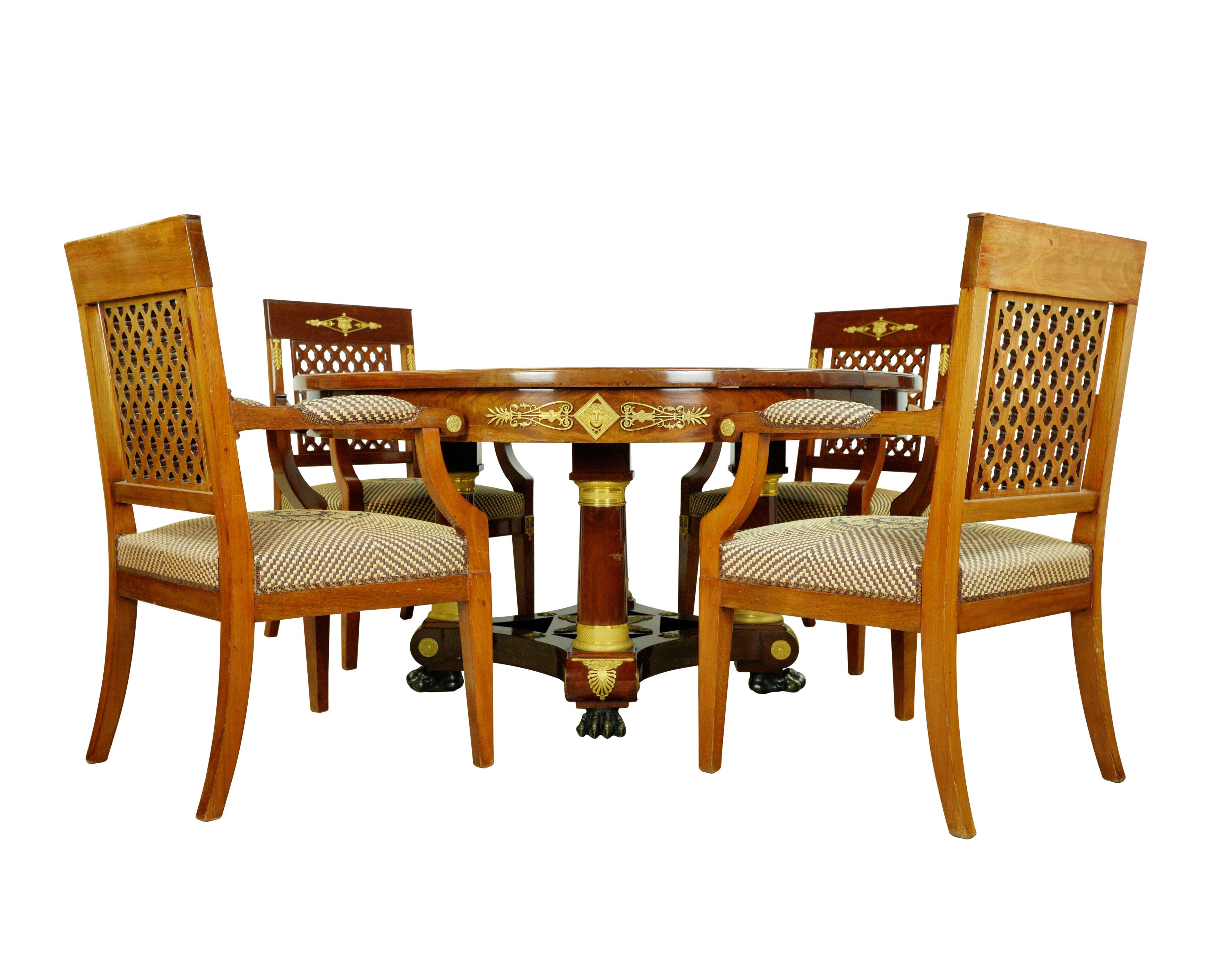 This exquisite furniture piece set from an estate in Greenwich, Connecticut. The set includes a table with four leaves and a total of twelve chairs, eight armless and four with arms. The chairs, crafted from medium-tone wood with lattice backs,