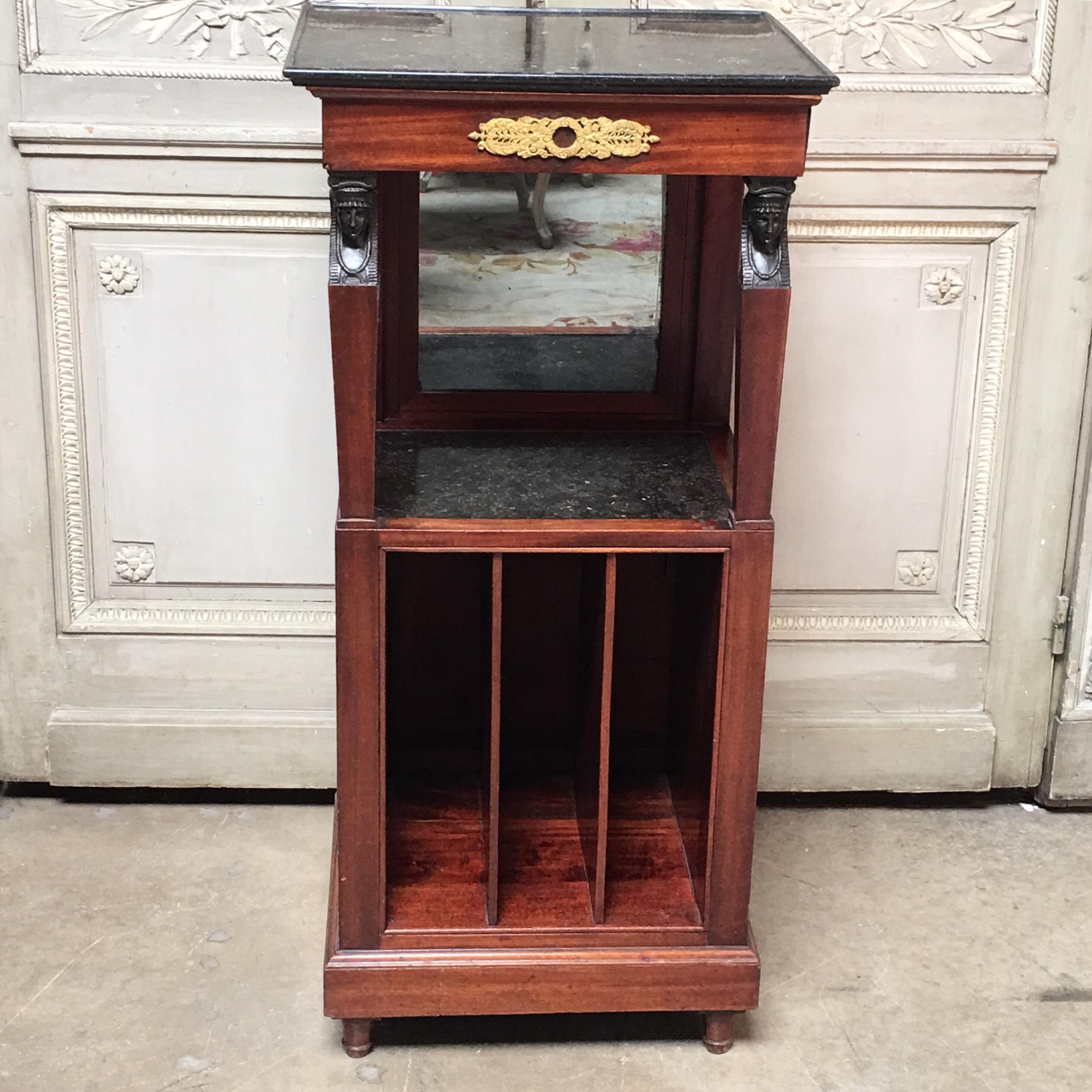 An early 19th Century French mahogany shaving stand with black marble top over a single drawer over a case with a marble top and three cubbies.  The mirror is resessable. 