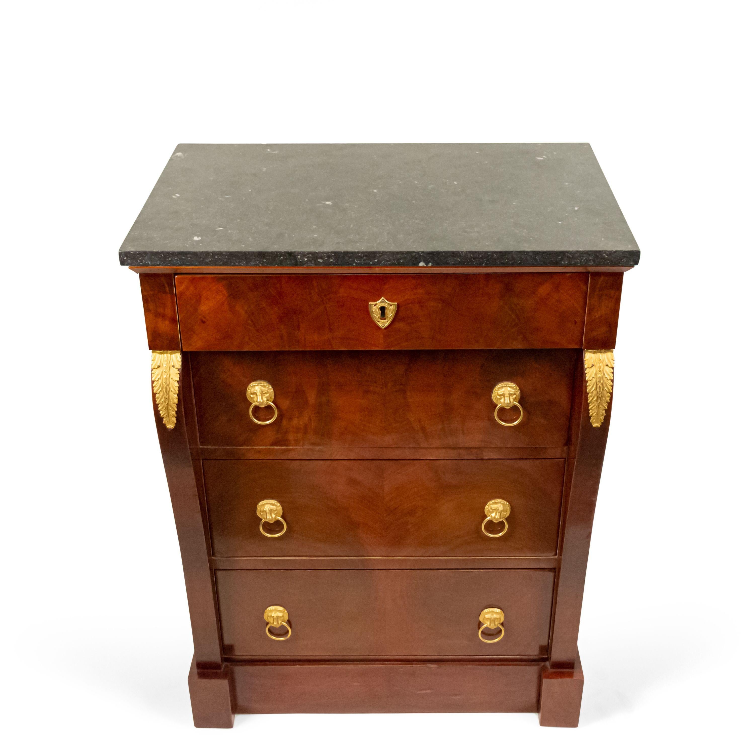 French Empire style late 19th century mahogany small chest with 4 drawers and bronze trim with a black marble top.