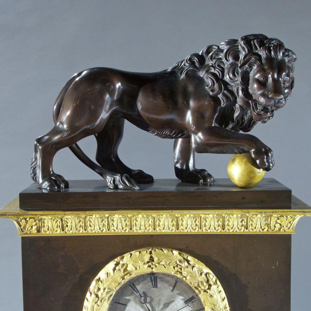 French early 19 century Empire mantel clock depicting Medici lions. The pair, one of which dated from the Roman period, were installed at the Villa Medici in Rome in 1598.