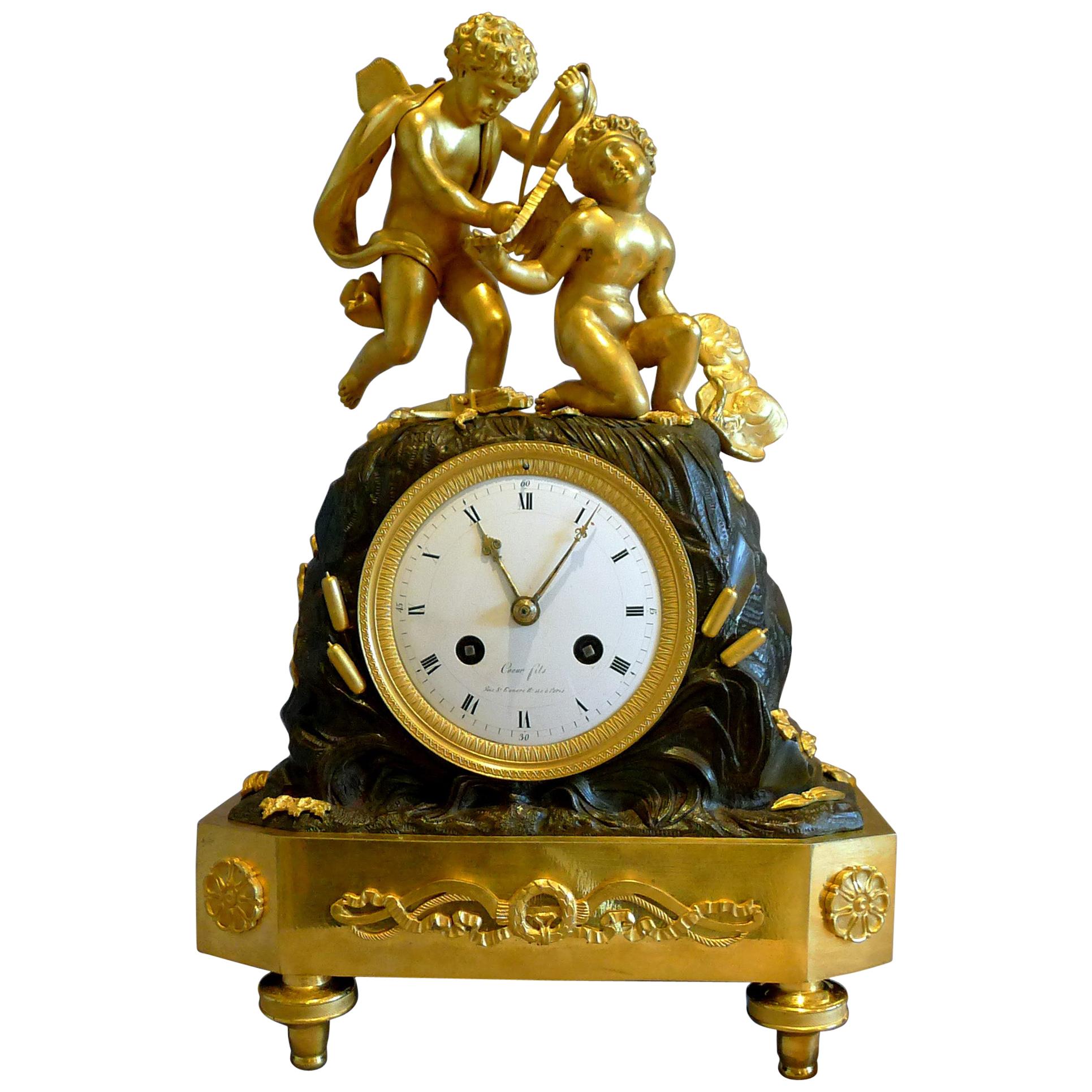 French Empire Mantel Clock of Two Cupids Signed Coeur For Sale