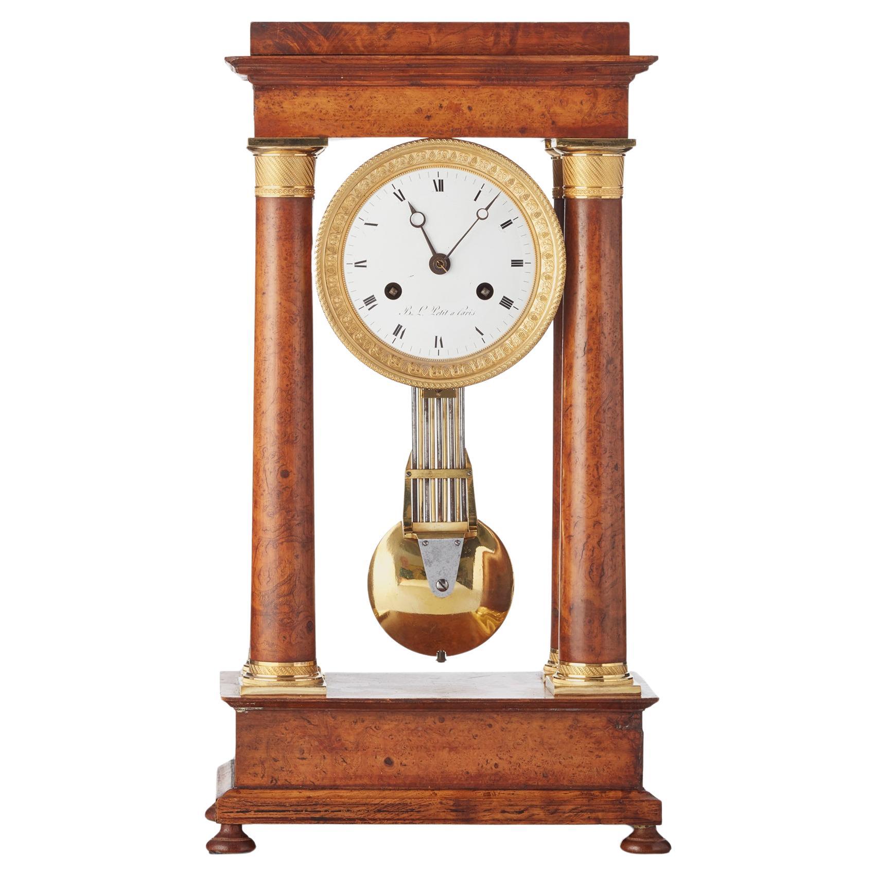 French Empire maple and gilt 4-column clock by B.L. Petit a Paris For Sale