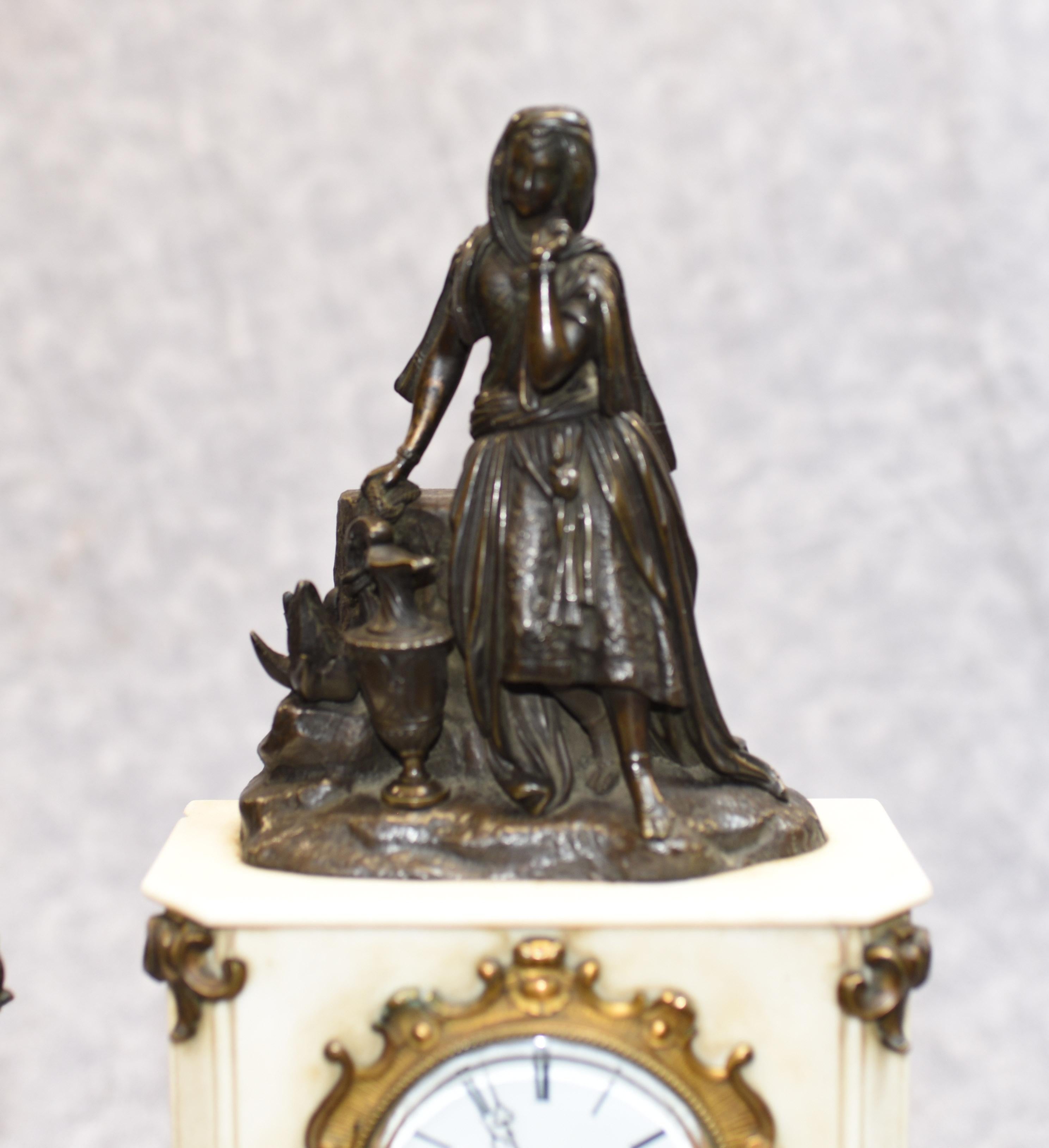 - Gorgeous French Empire antique clock set
- Mantle clock is flanked by two bronze urns on pedestals
- Clock is surmounted by bronze female maiden figurine
- Great collectors piece and we date this clock garniture set to circa 1910
- Bought from