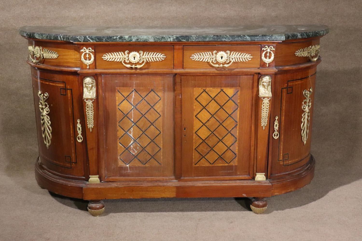 Wood. Brass figural and brass accents. Marble top. 4 dovetailed drawers. Inlaid. 4 doors containing 1 shelf. 42 3/4