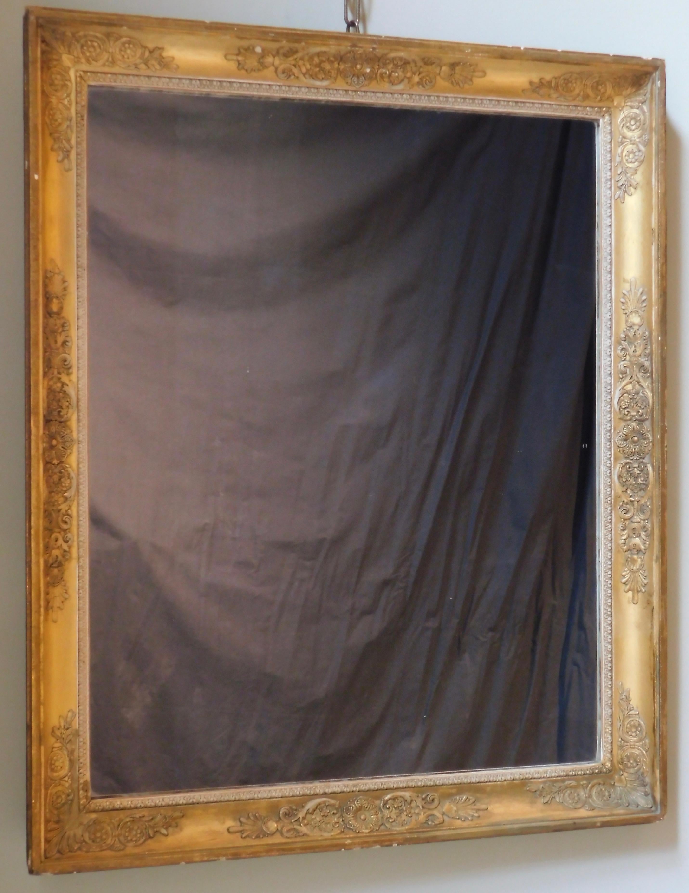 19th century French empire mirror of carved wood and gesso. Gilt and painted. This mirror can be hung vertically or horizontally and would be an excellent choice to use in a bathroom or small entry. The glass is quite heavy and is from the late 20th