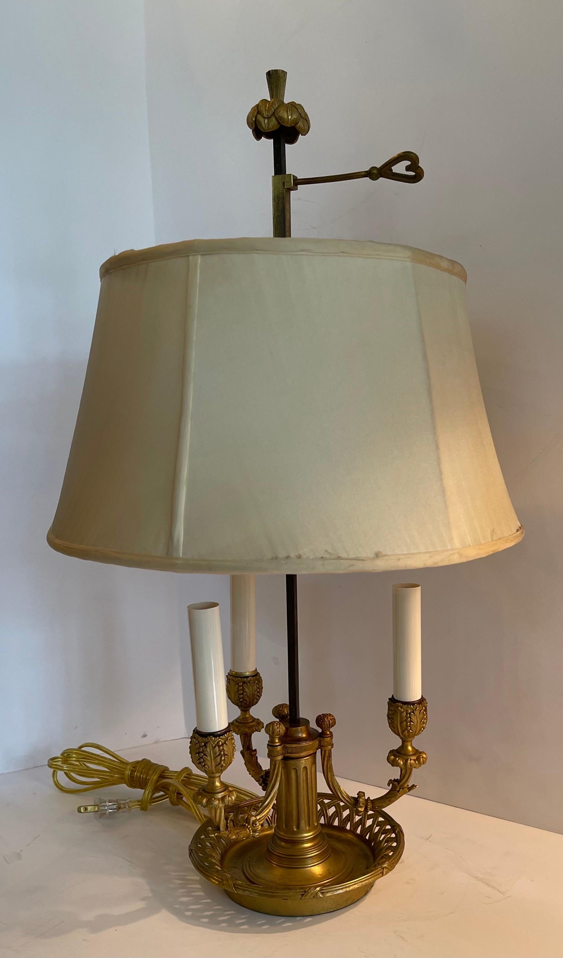 A wonderful French Empire / Neoclassical bronze three candelabras bouillotte lamp with silk shade.