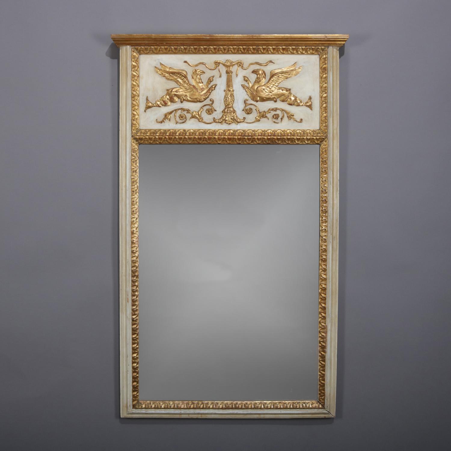 French Empire neoclassical trumeau wall mirror features gilt and whitewash painted frame with upper reserve having central gilt column with flanking phoenix, 20th century.

Measures - 49