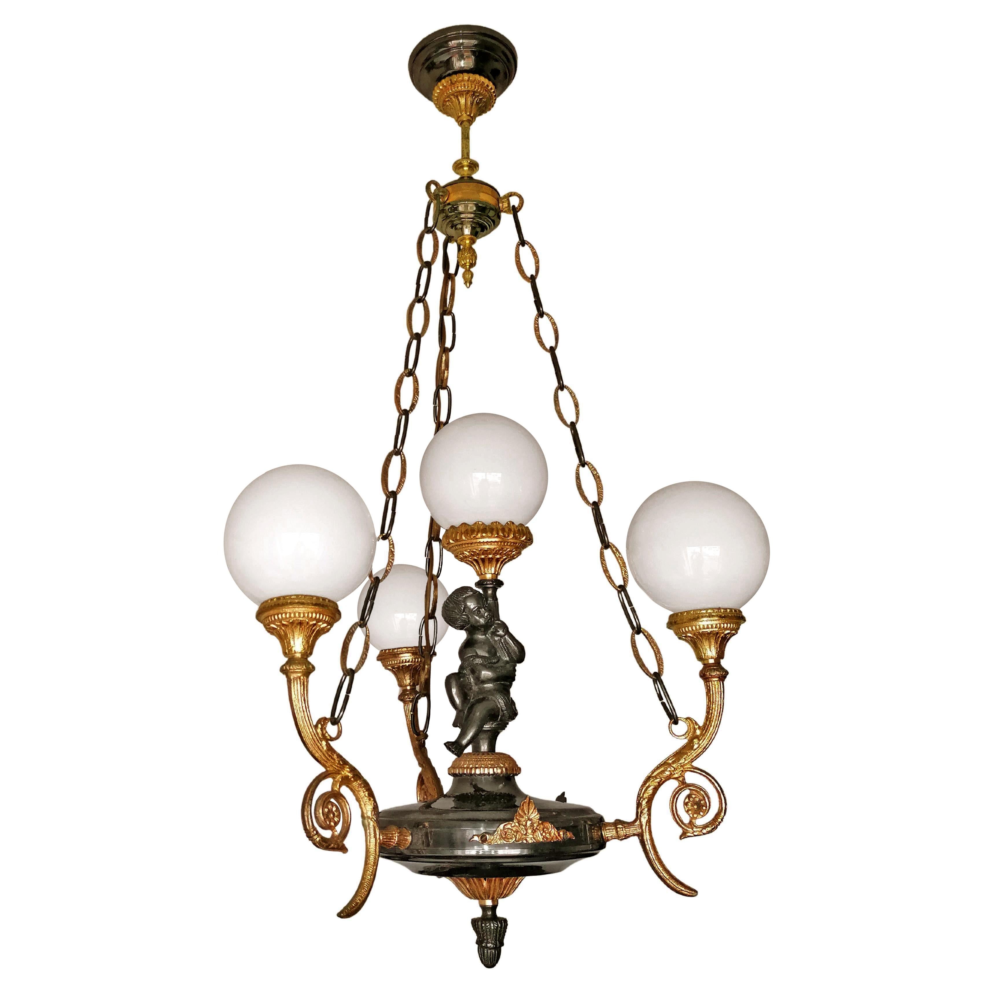 Spectacular neoclassical French Empire gilt bronze 4-light chandelier, patinated and gold-plated solid bronze

Dimensions
Height 39.38 in. (100 cm)
Diameter 23.63 in. (60 cm)
Glass shades, 6 in (15 cm)
4-light bulbs E 14/good working