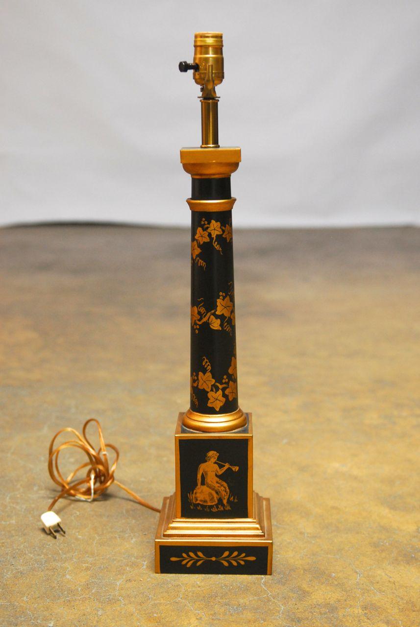 Exquisite French Empire tole lamp featuring a columnar form with gilt decoration over a black background. Hand-painted wreaths and vines adorn the column with a maiden playing a horn on one side of the base. Signed by maker on the bottom. Made in