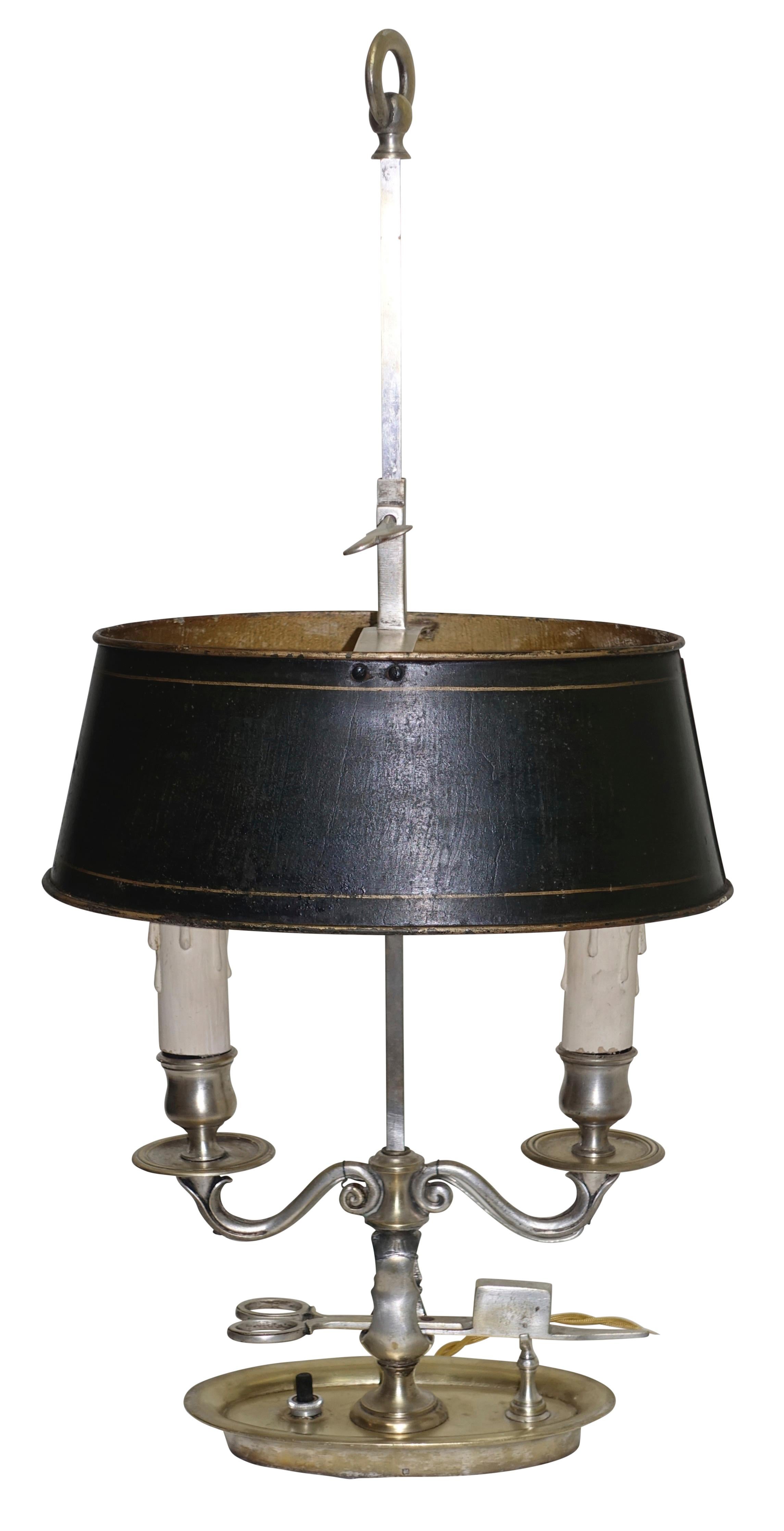 Empire period nickel and nickel plated brass oval shape Bouillotte two candle lamp, now electrified. Having a black painted tole adjustable shade and unusual wick scissor holder, France, early 19th century.