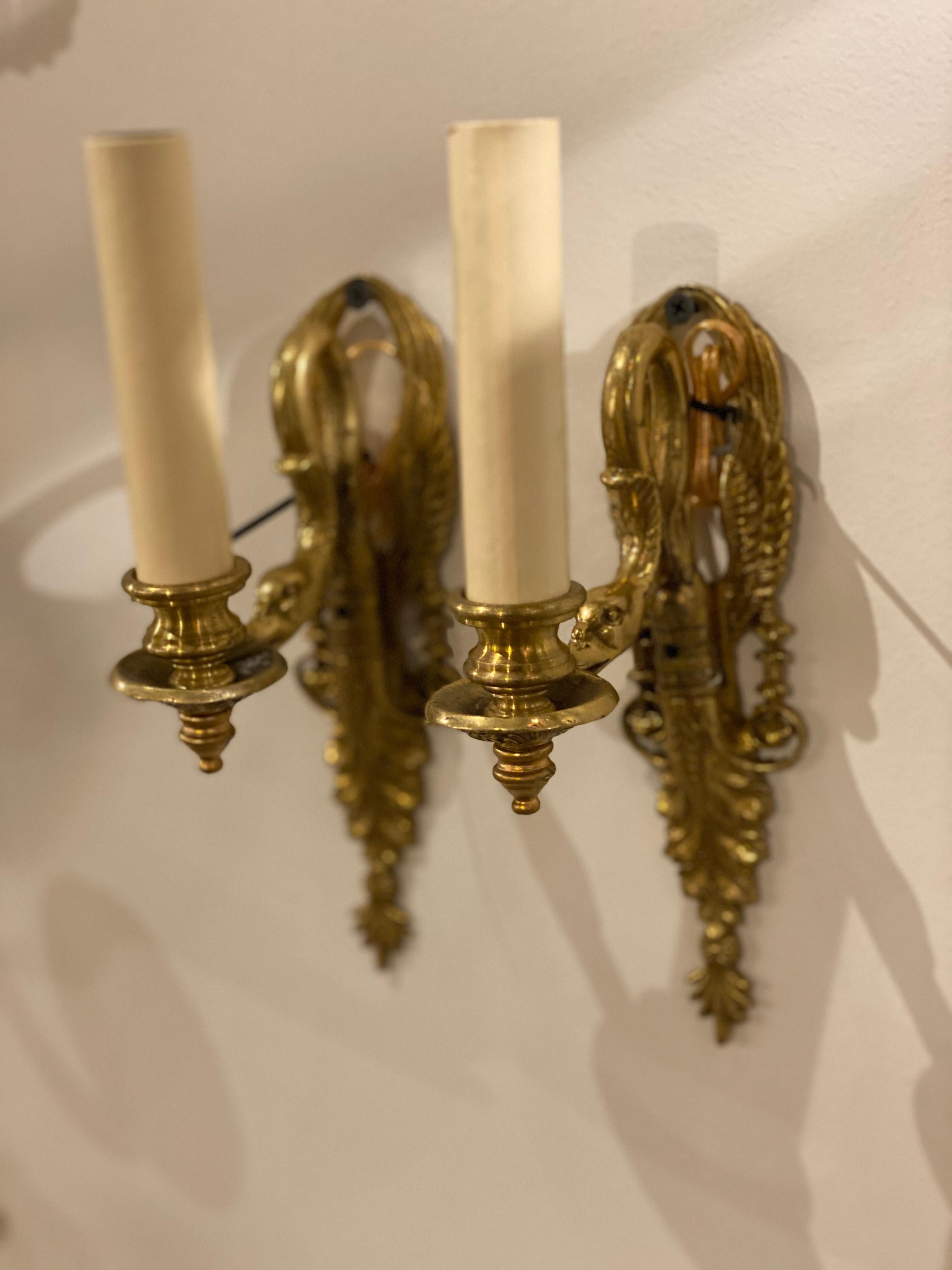 A pair of circa 1920’s French empire style one light sconces with swans head. In very good vintage condition. 

Dealer: G302YP 
 