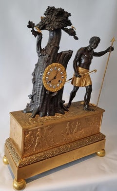 Pendule de cheminée Empire français en bronze patiné et doré