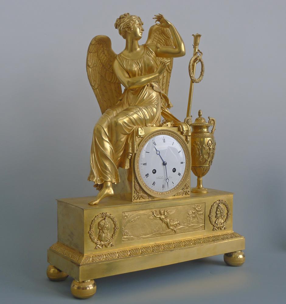 French Empire antique ormolu mantel clock of the Goddess Iris sitting on the clock housing. Very fine quality casting and superb ormolu. The figure of Iris is very well cast and finished in matte and burnished ormolu. To her right is a magnificent