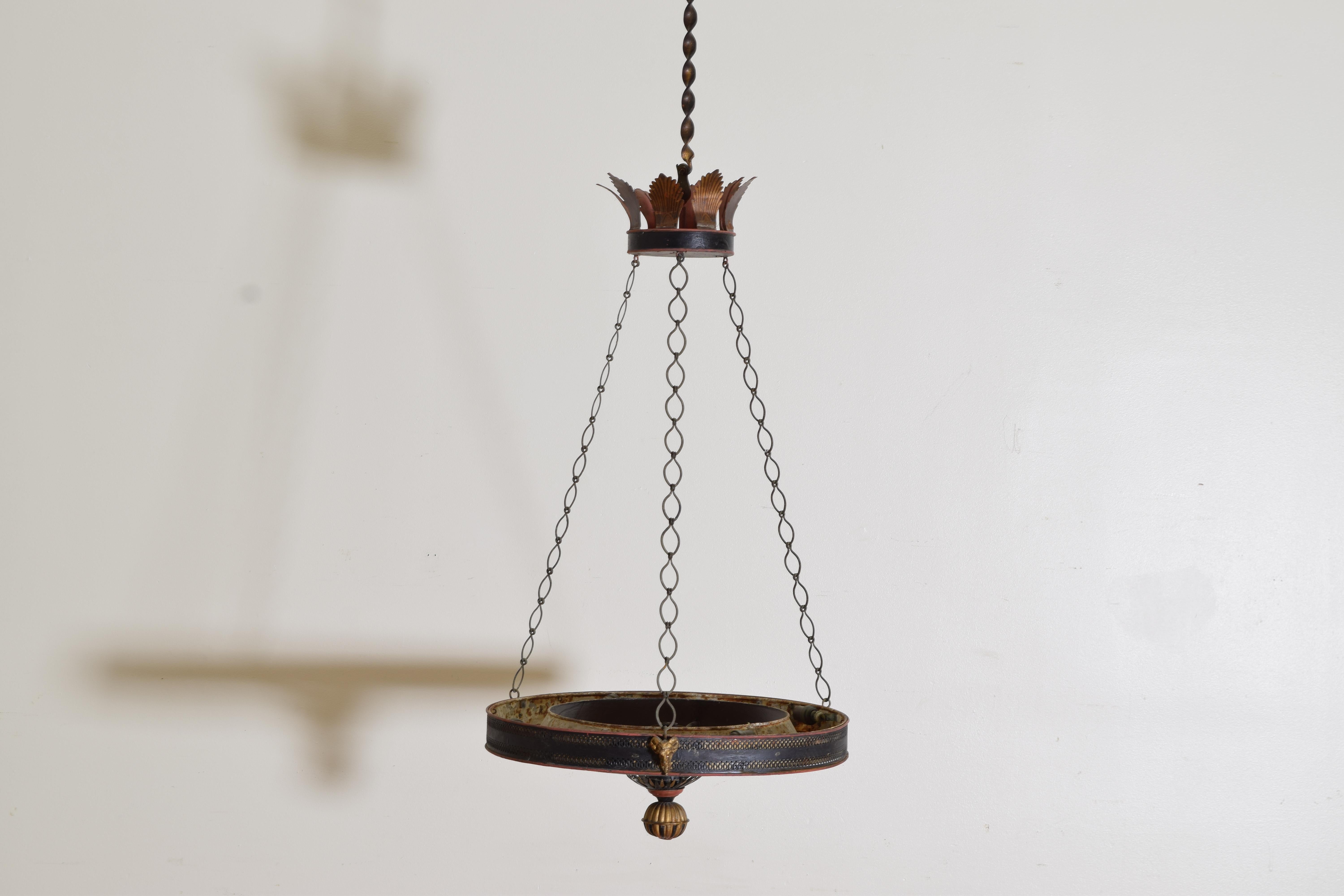 Completely original with a canopy of palm fronds issuing three lengths of hand forged chain supporting a large perforated ring with a stretcher that originally held lamp oil, now wired with a central candle light and hidden up lights inside the