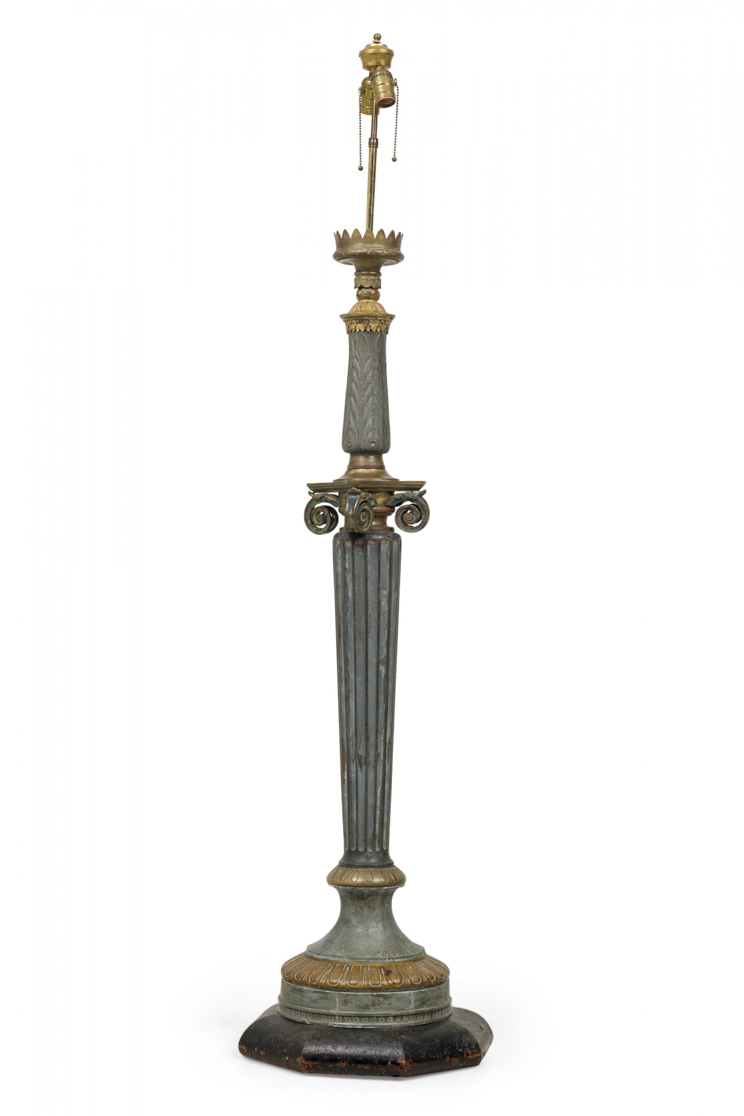 French Empire-style floor lamp with an Ionic columnar form, constructed in aluminum and brass with a heavy patina and mounted with a brass two-light fixture and a black painted wooden base.