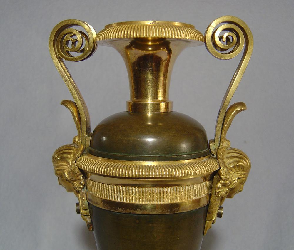 A magnificent quality French Empire/Directoire urn in superb original condition. Constructed of lovely patinated bronze, fire gilded Ormolu and griotte marble. In the gout d'Egypt or Egyptian revival taste of the time the mounts to the side are of