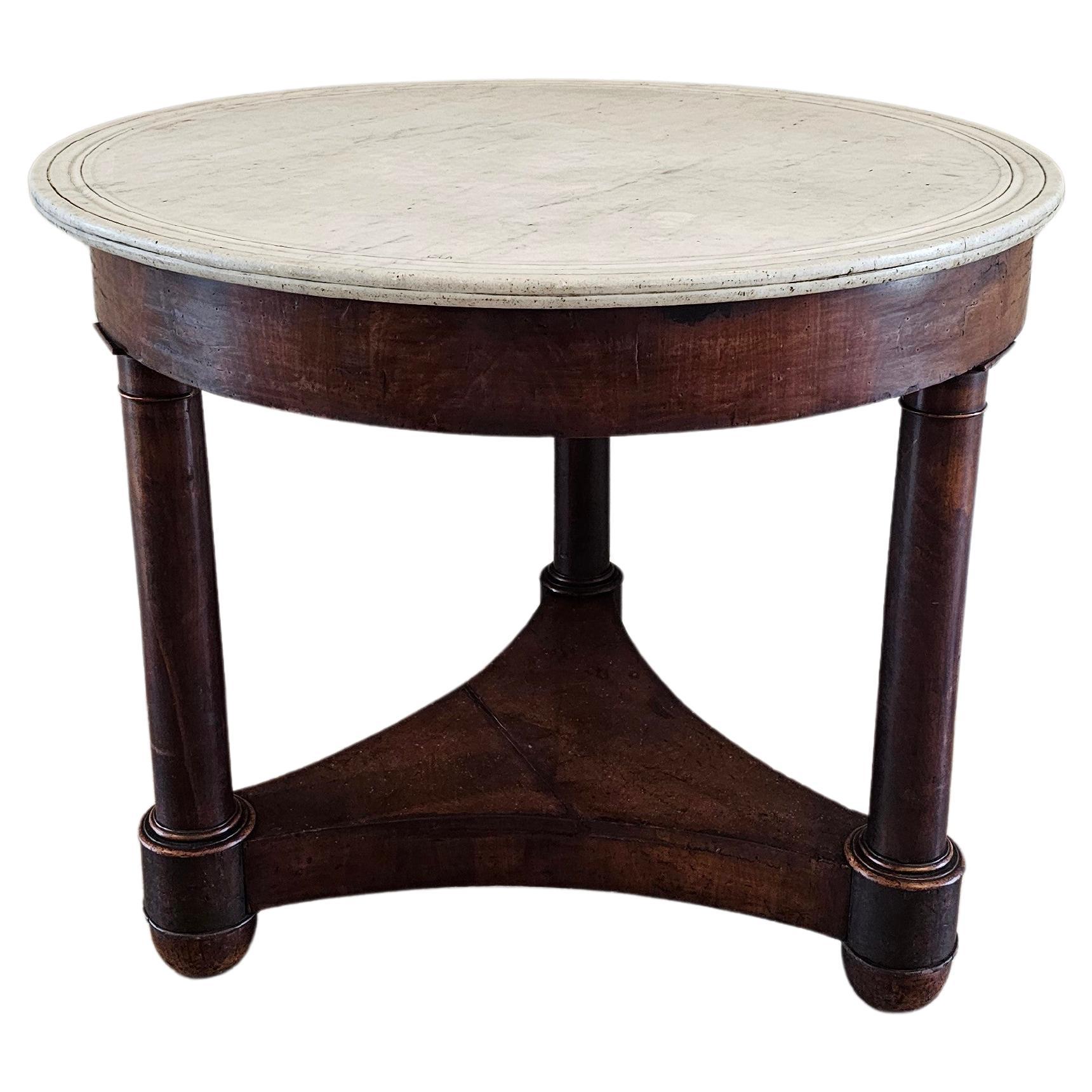 A 200 year old period French Empire mahogany pedestal table guéridon with beautifully aged heavily worn warm rich dark patina. circa 1810

Hand-crafted in France in the early 19th century, have a white dished double molded marble top, over