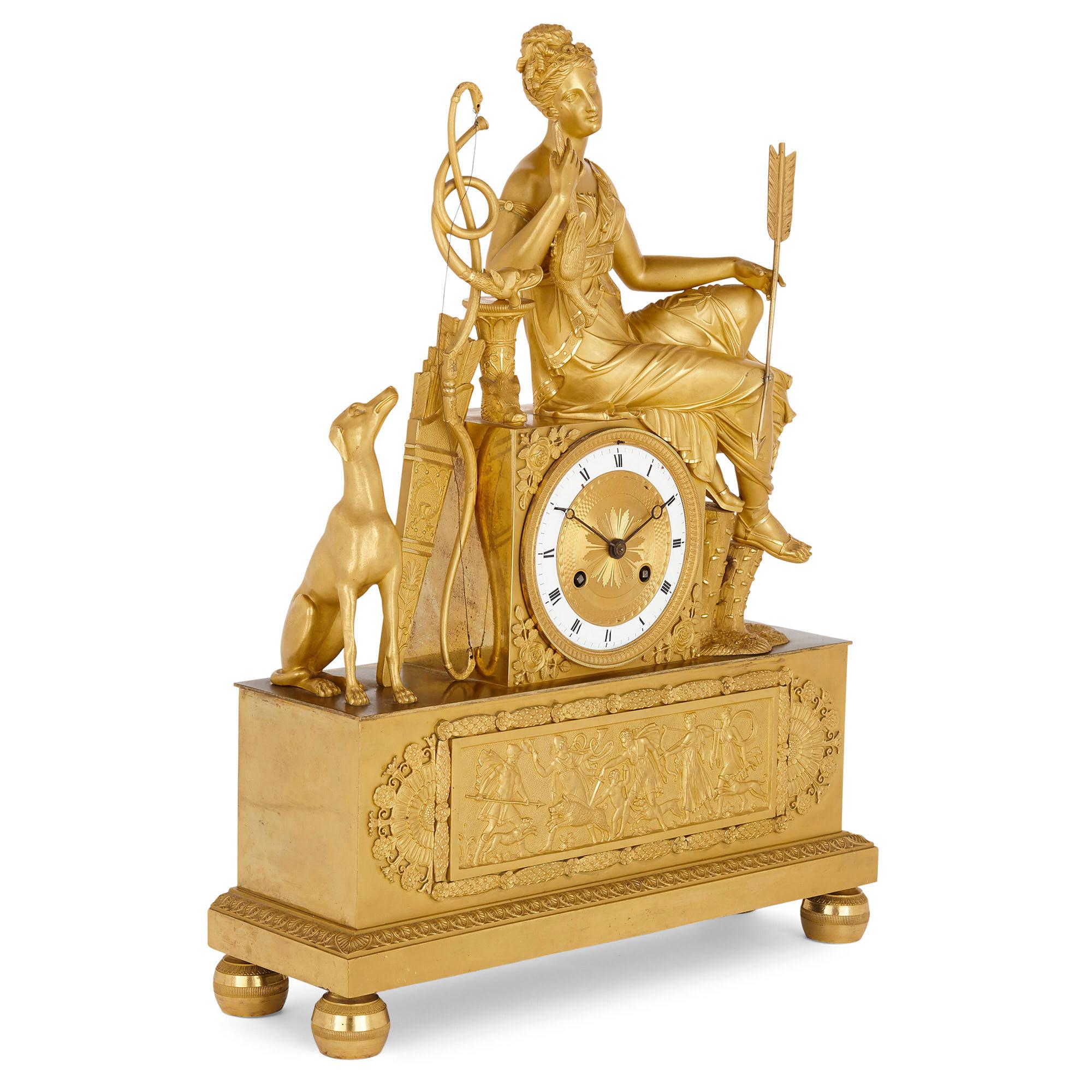 French Empire period gilt bronze mantel clock
French, early 19th century
Measures: Height 50cm, width 36cm, depth 12cm

This mantel clock, wrought from gilt bronze during the French Empire period, features a rectangular base, set above four bun