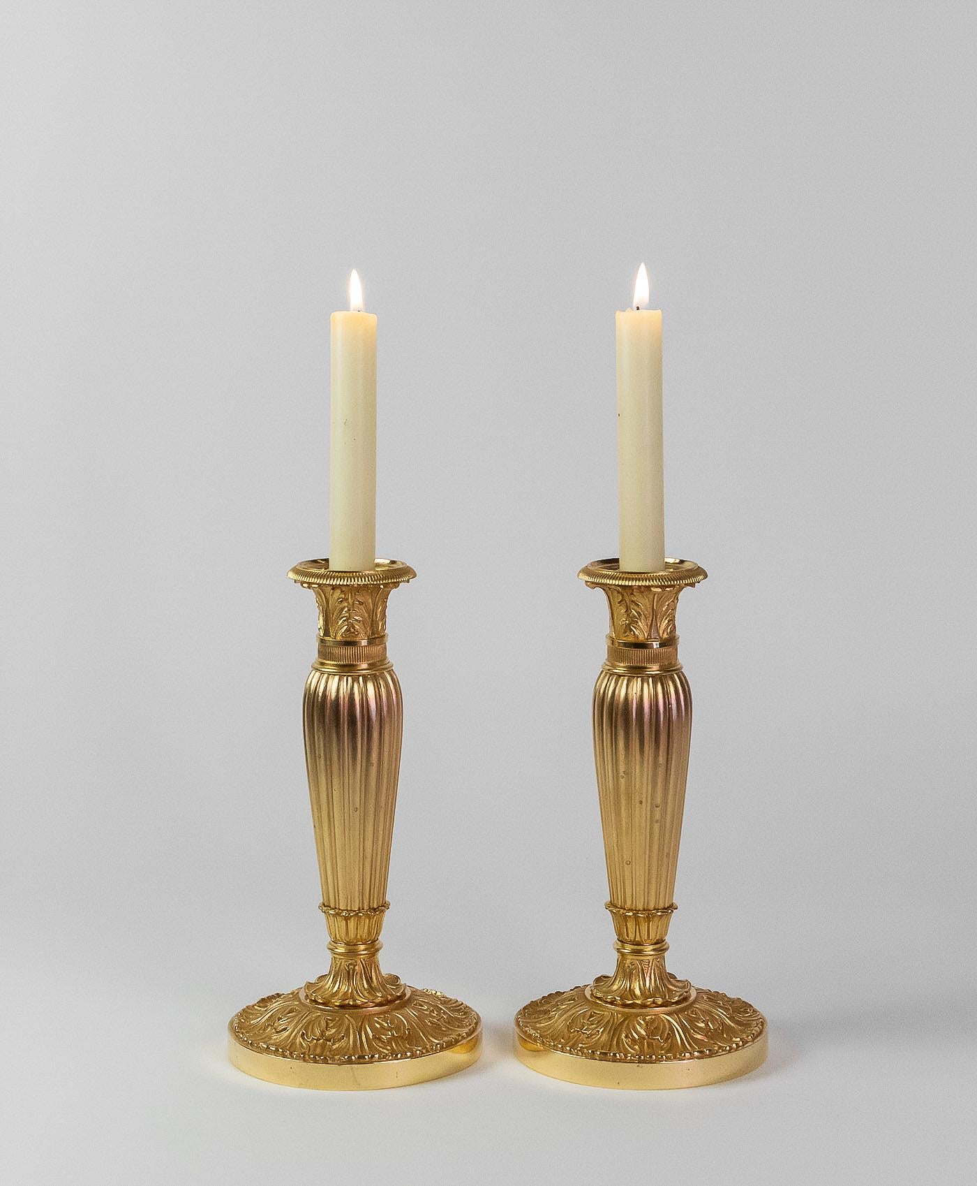 French Empire Period, pair of chiseled gilt-bronze candlesticks, circa 1805-1810.

An elegant pair of gilt-bronze candlesticks. Our candlesticks present a beautiful finely chiseled work of palmettes on the base.

Lovely French Empire period