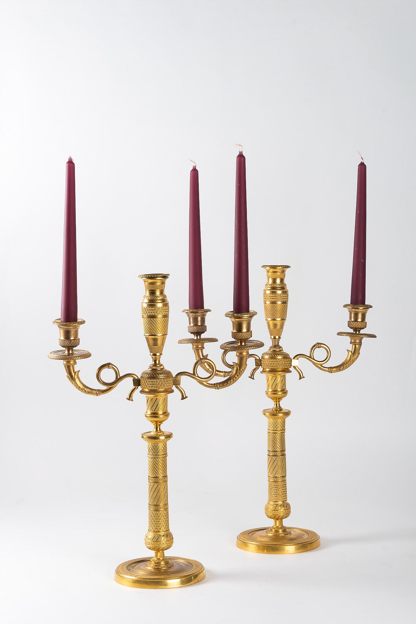 French Empire period pair of gilt bronze candelabras, circa 1810.

A gorgeous pair of chiseled gilt bronze three-arm candelabras, the scrolling arms are detachable, converting the pieces to single candlesticks.

Beautiful Parisian work,