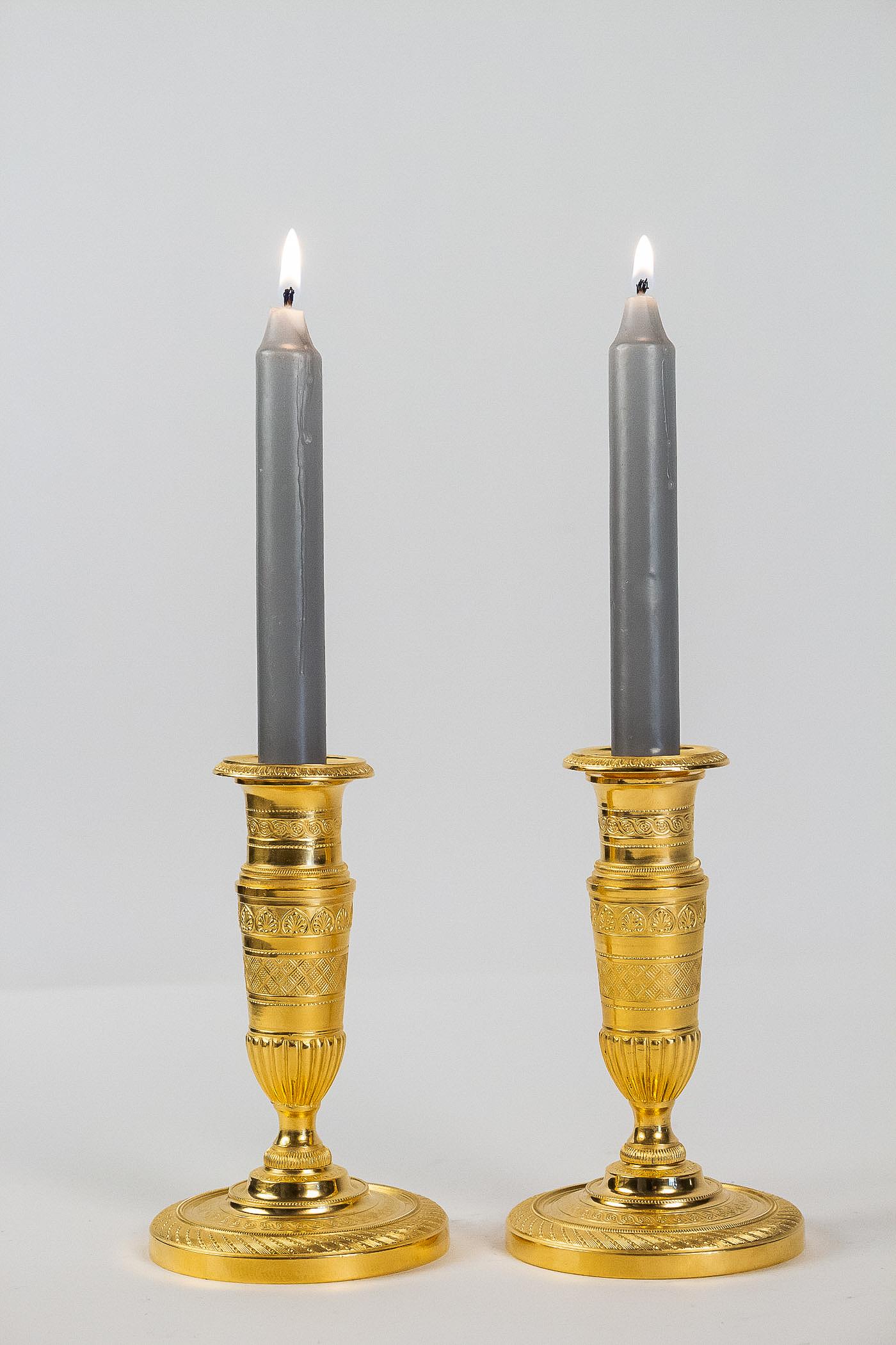 French Empire period, pair of small gilt bronze candlesticks, circa 1805.

A rare and elegant pair of small gilt bronze candlesticks, called “Ragots.”. Our candlesticks present a beautiful work of Fine shears, palmettes, interlacing, and geometric