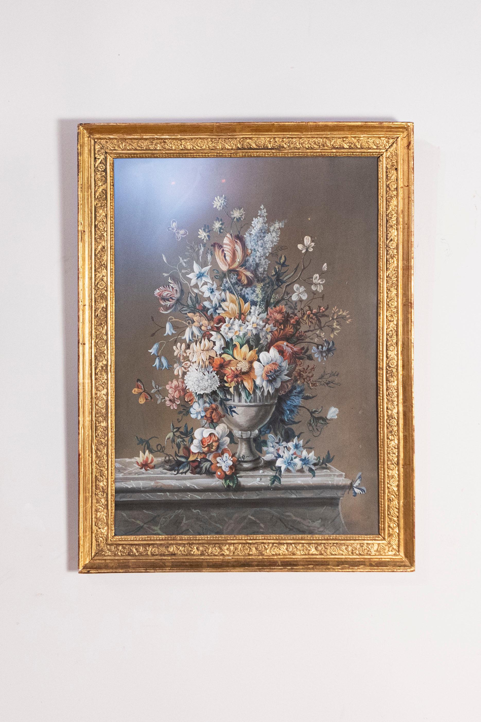 A French Empire period floral pastel and gouache painting from the early 19th century, in giltwood frame. This French painting features an exquisite depiction of a bouquet of flowers set inside a metal vase, adorned in its upper section with what