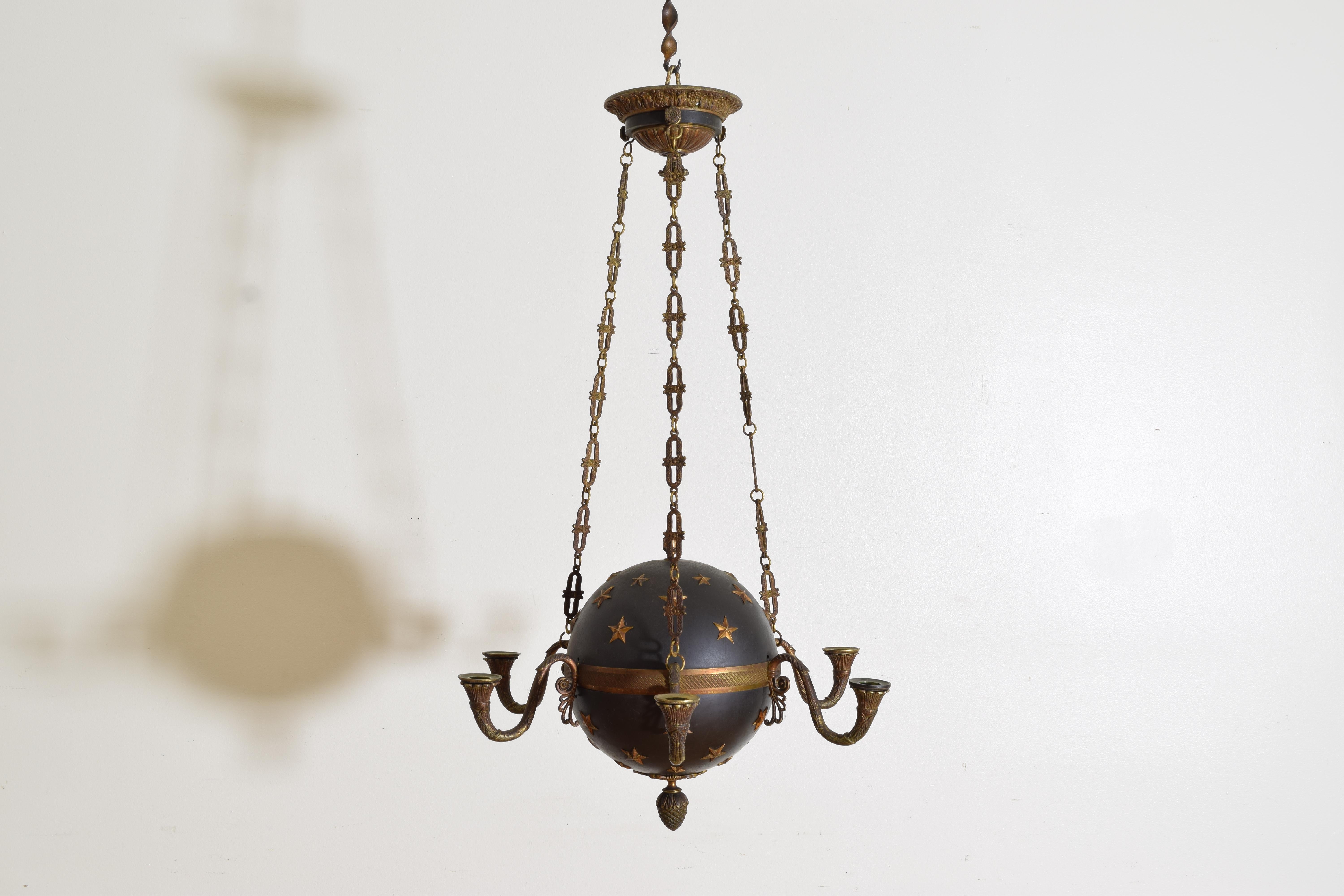 completely original and in unrestored condition this globe chandelier is constructed entirely of heavy guage painted tole and bronze, hanging from a canopy with finely cast chain the globe with two sizes of applied stars, the globe with a centered