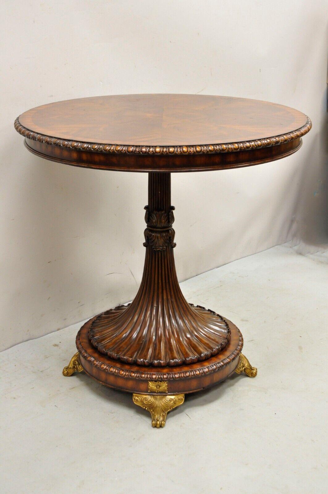 French Empire Regency Style round mahogany pedestal base lamp side table. Item features ornate brass foot, carved pedestal base, beautiful wood grain, nicely carved details, great style and form, possibly by Theodore Alexander or Maitland Smith.