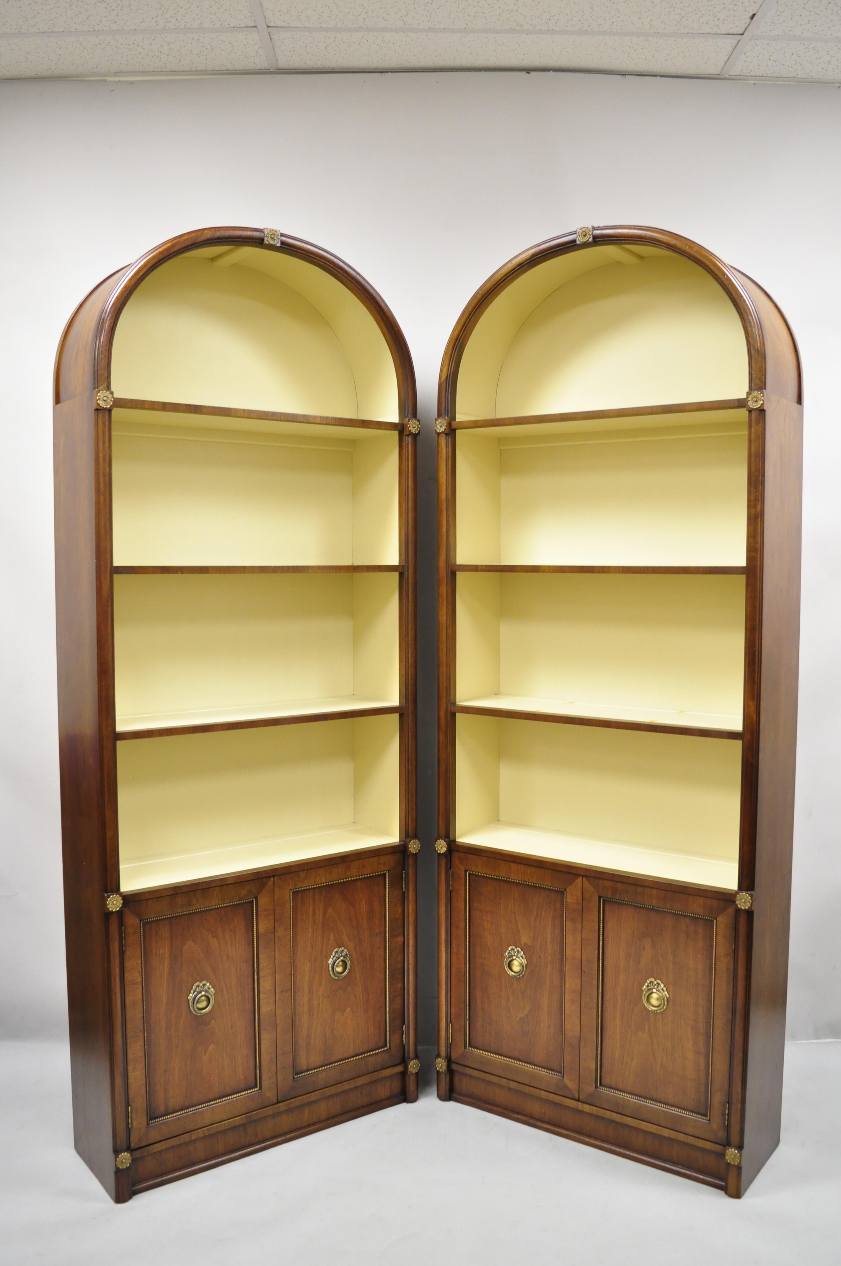 French Empire Hollywood Regency tall arched dome walnut etagere Curio cabinets - a pair. Item features tall arched dome tops, beautiful wood grain, 2 swing doors, 3 wooden shelves, solid brass hardware, quality American craftsmanship, great style